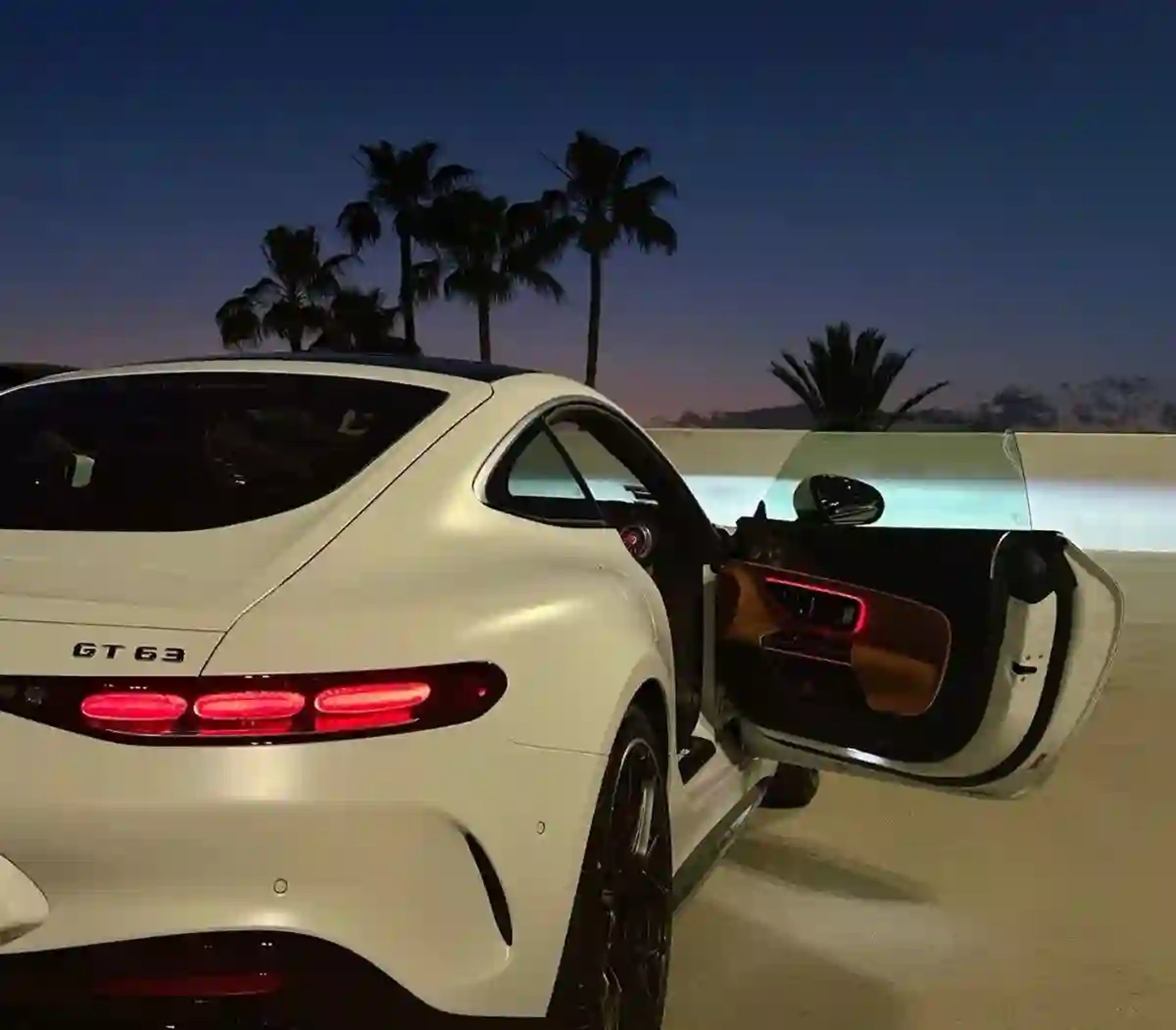 A blue sports car parked in a parking lot