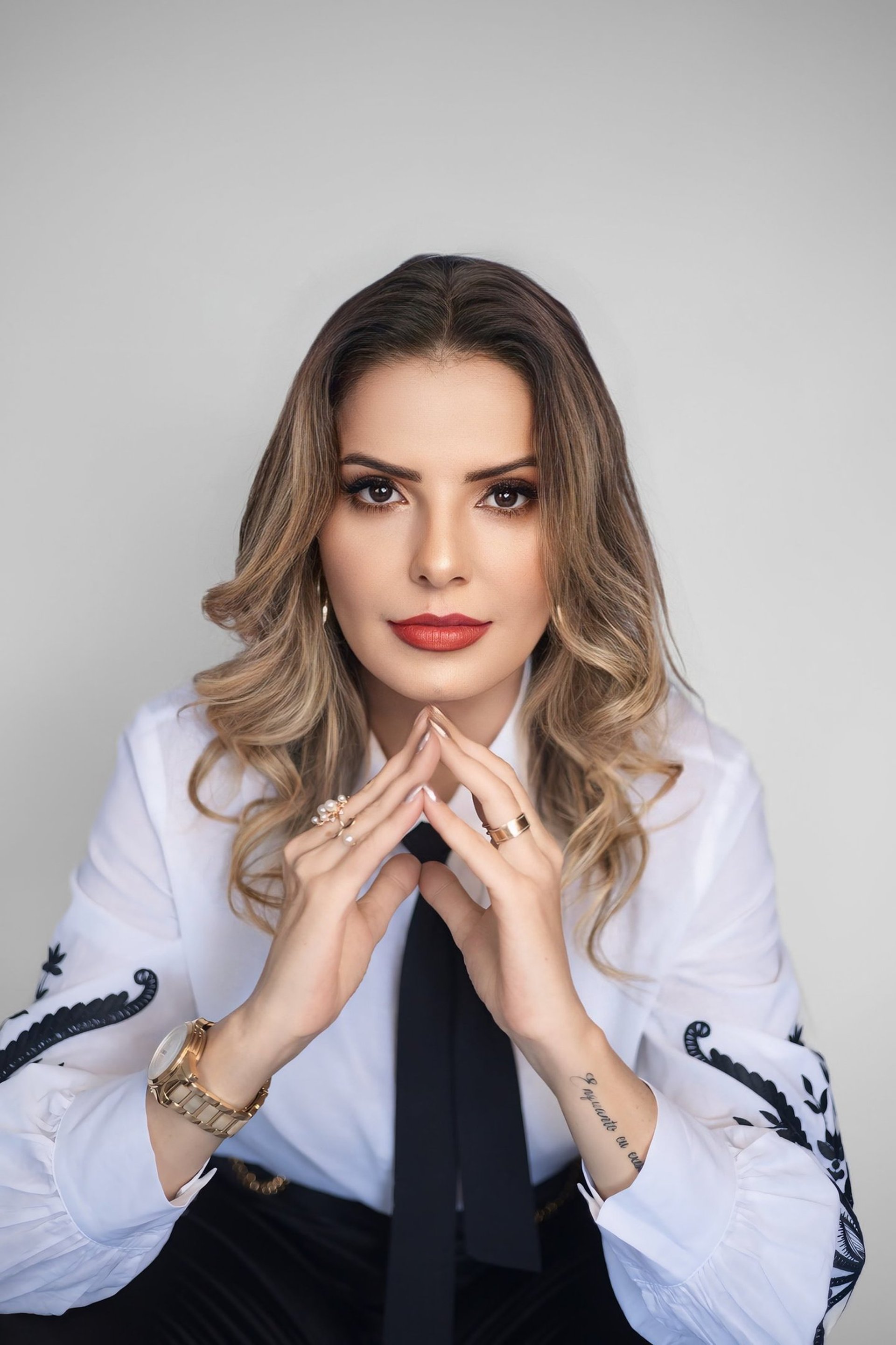 a long hallway with a checkered floor and paintings on the walls