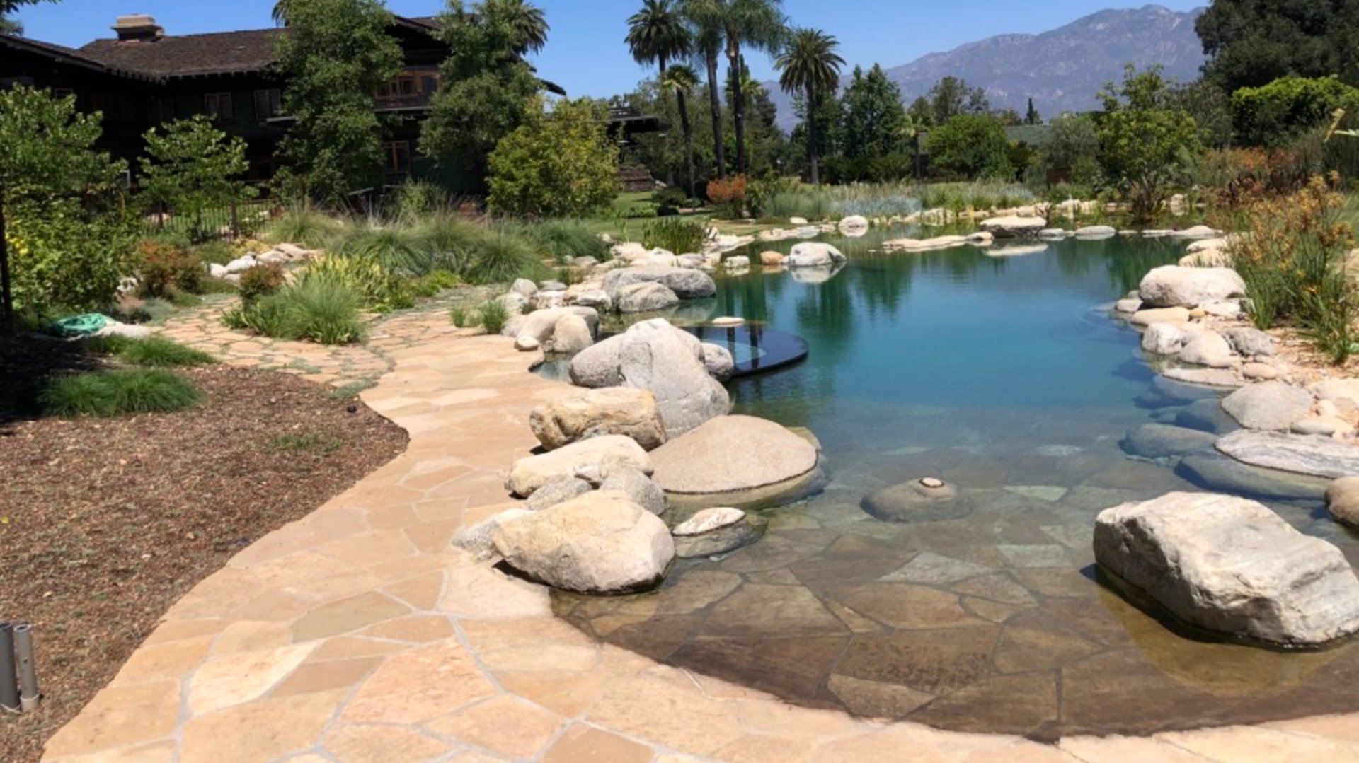 an abstract photo of a curved building with a blue sky in the background