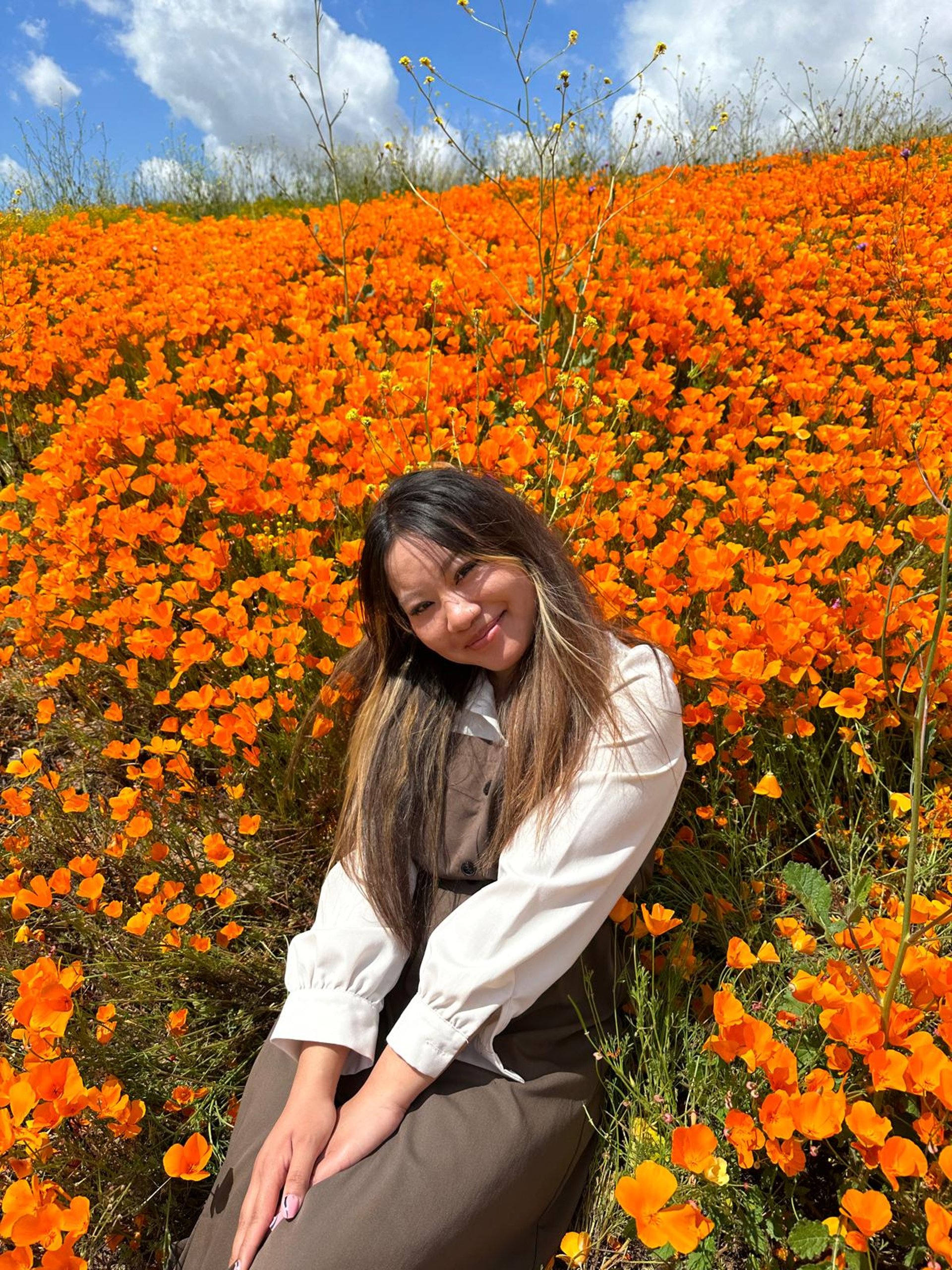 Kristie in an orange flower field.