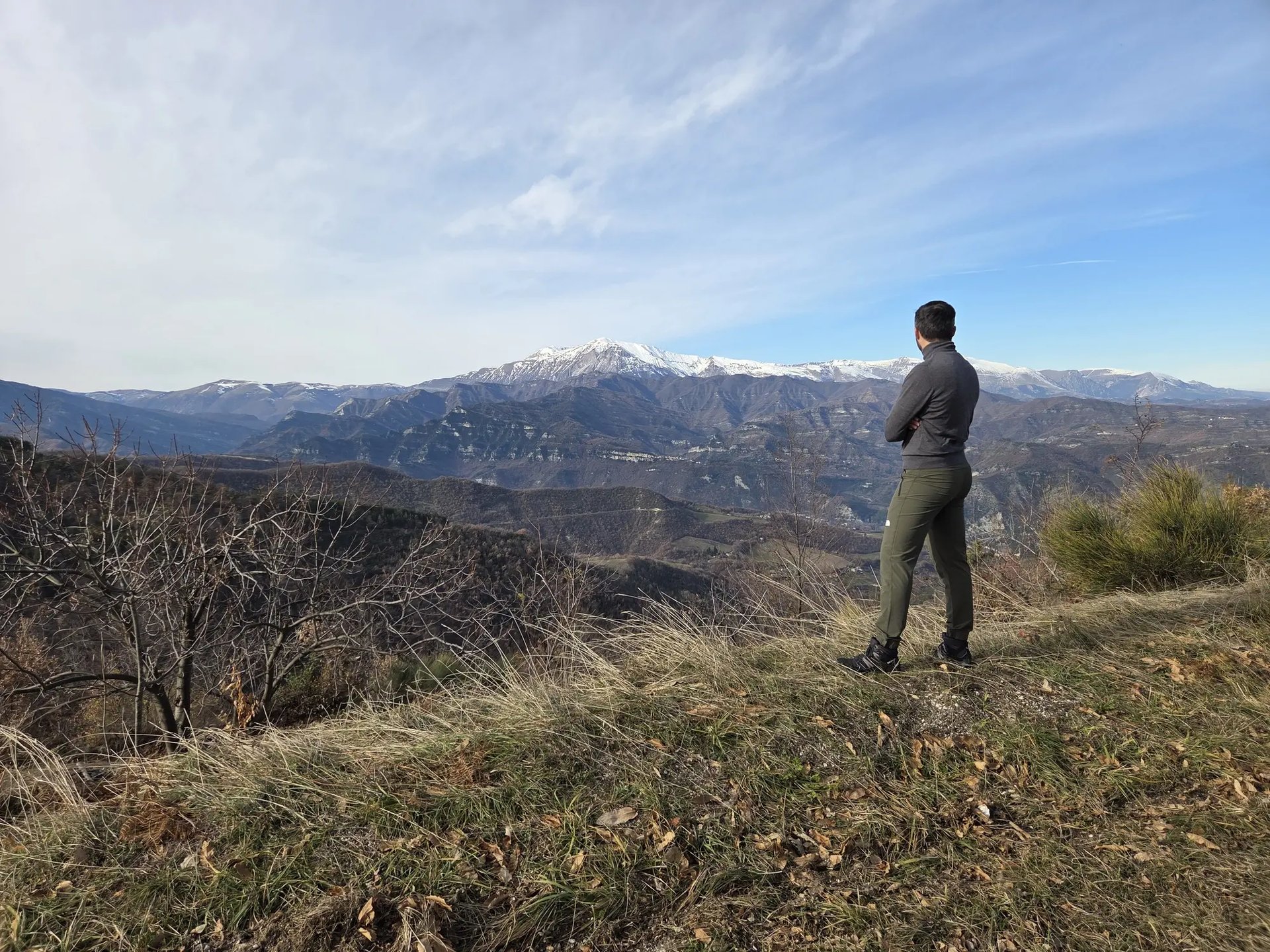brown concrete building near green trees under blue sky during daytime