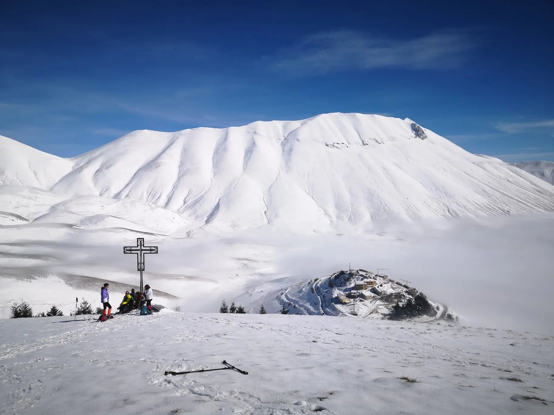 brown concrete building near green trees under blue sky during daytime