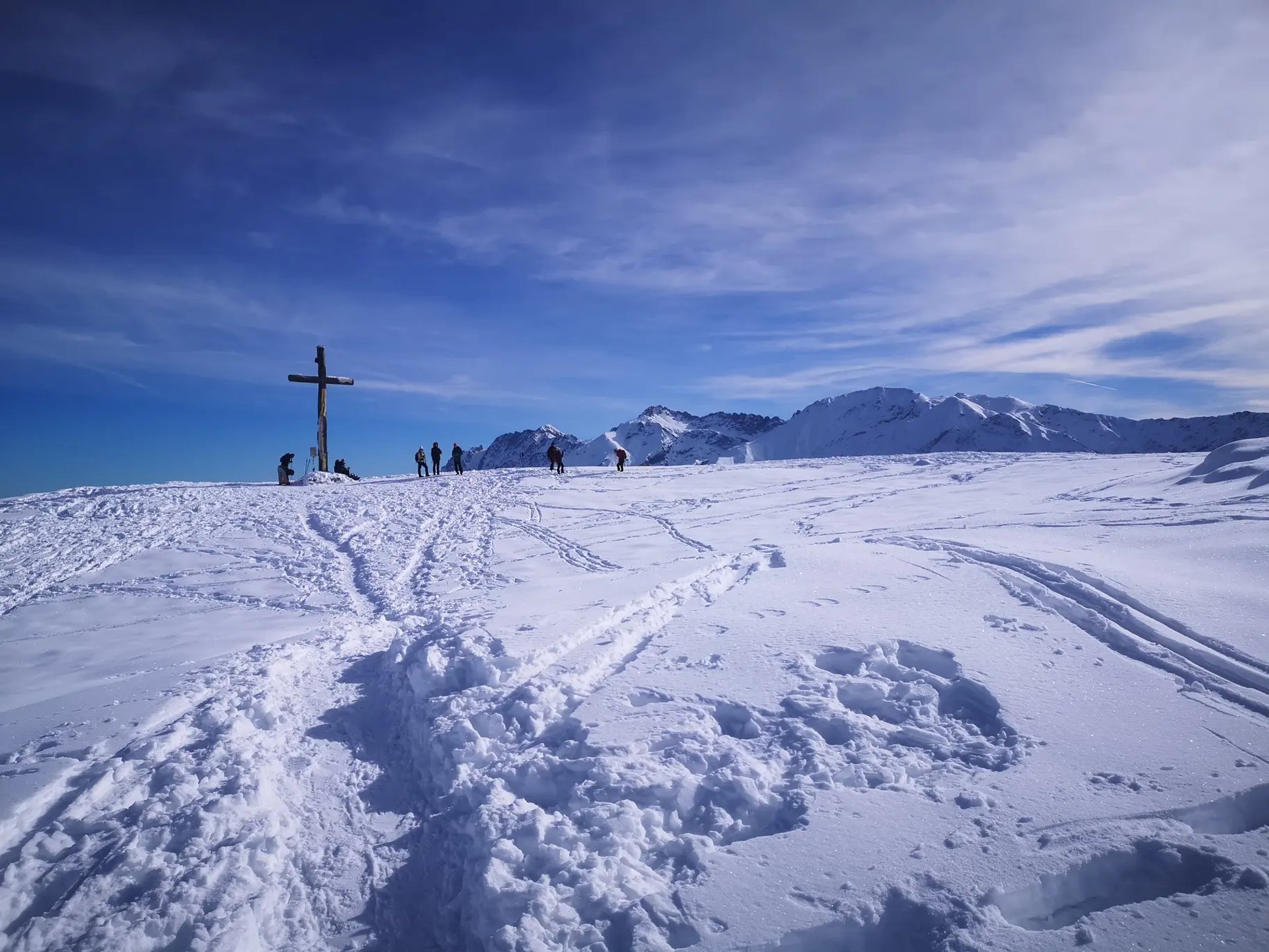 brown concrete building near green trees under blue sky during daytime
