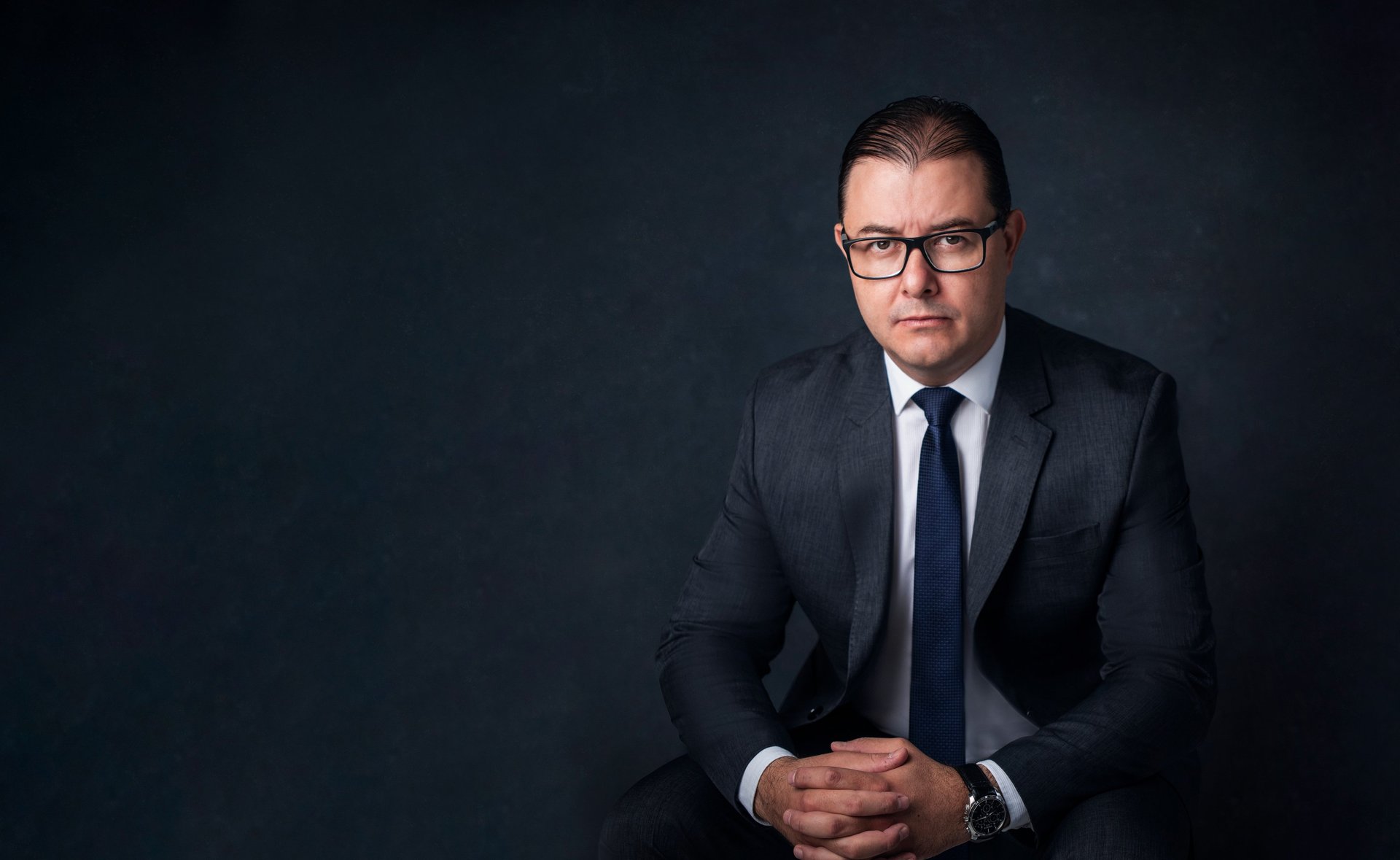 an abstract photo of a curved building with a blue sky in the background