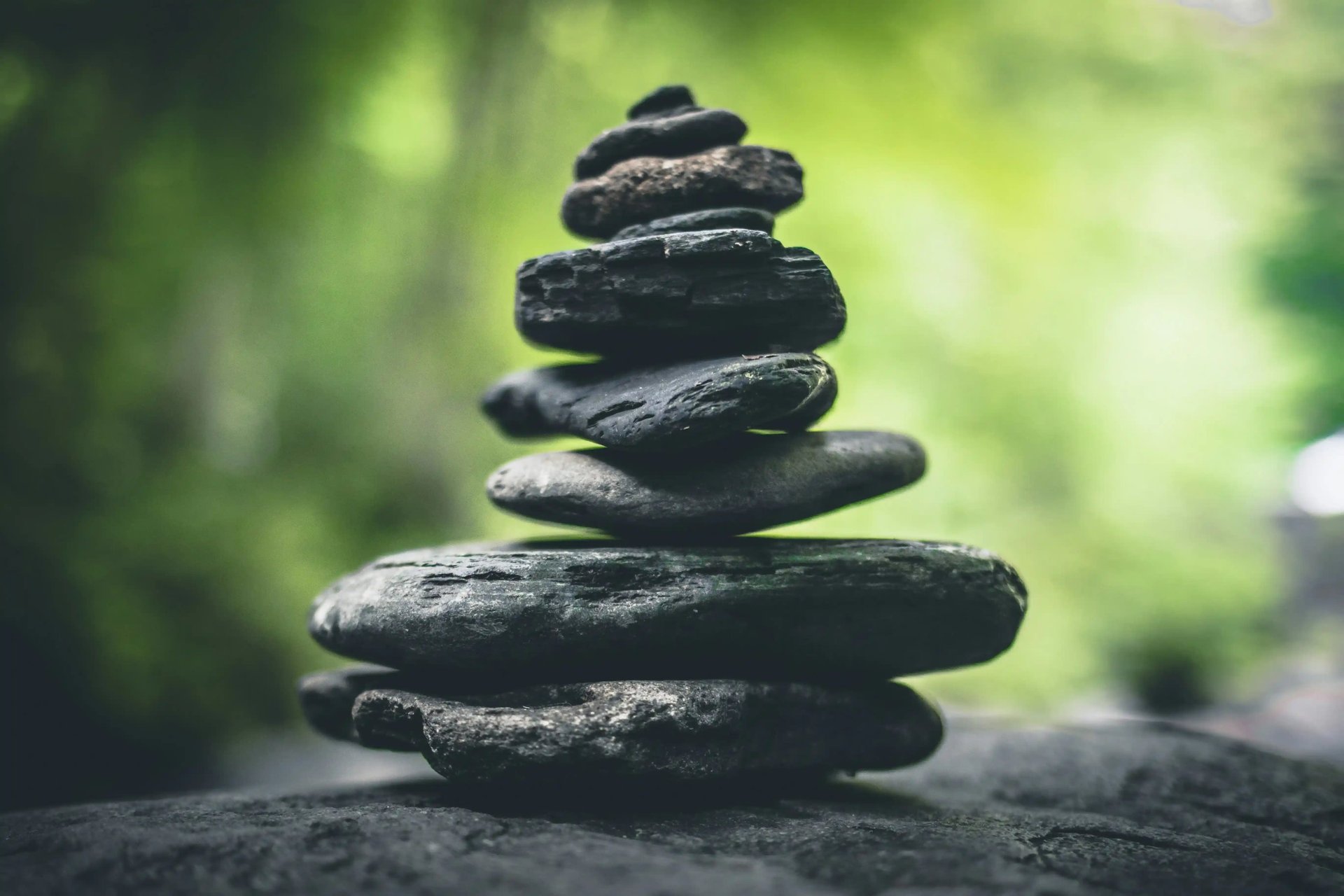 Stacked stones in balance, symbolizing values of dignity and presence in counseling.