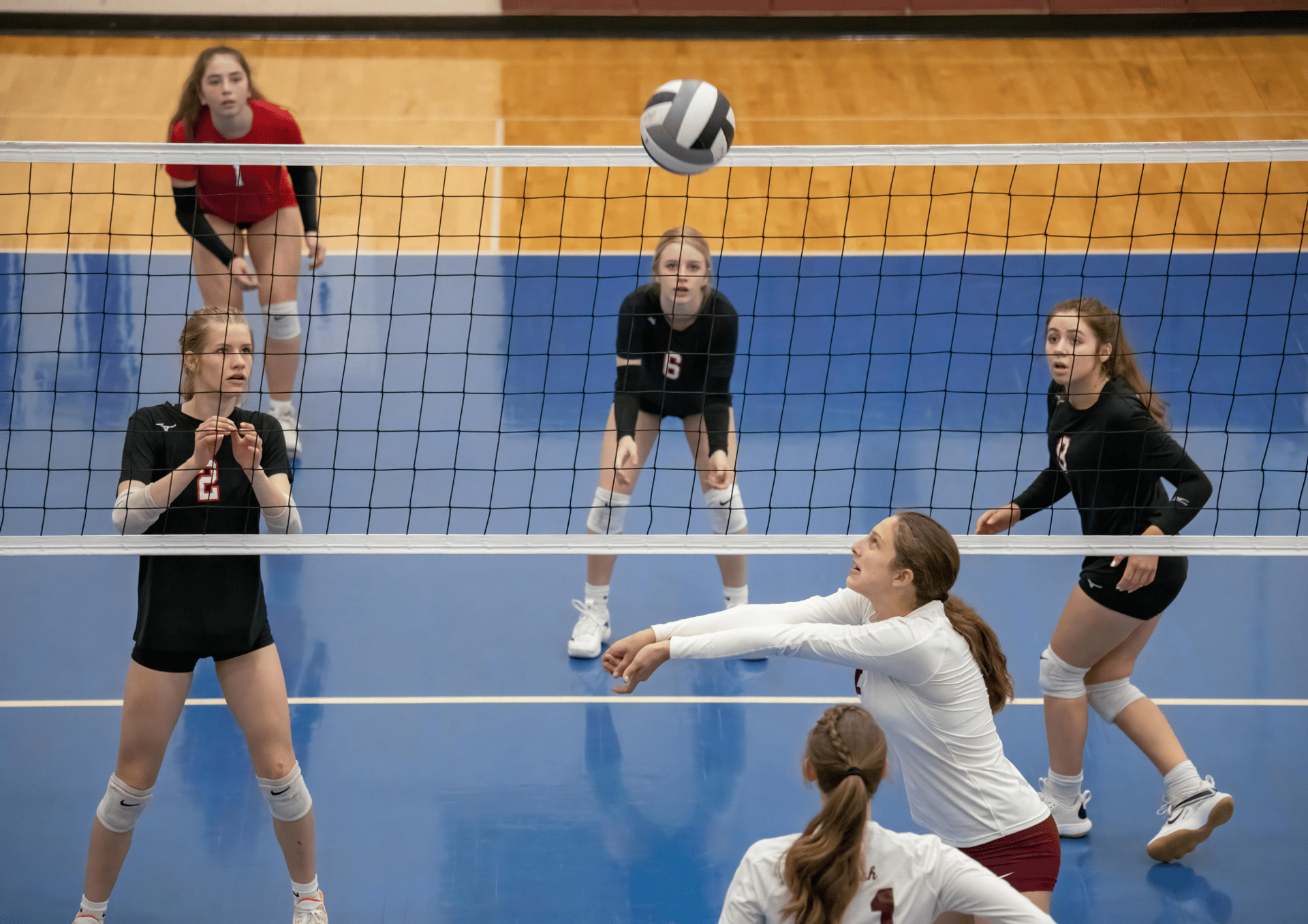 women playing volleyball inside court