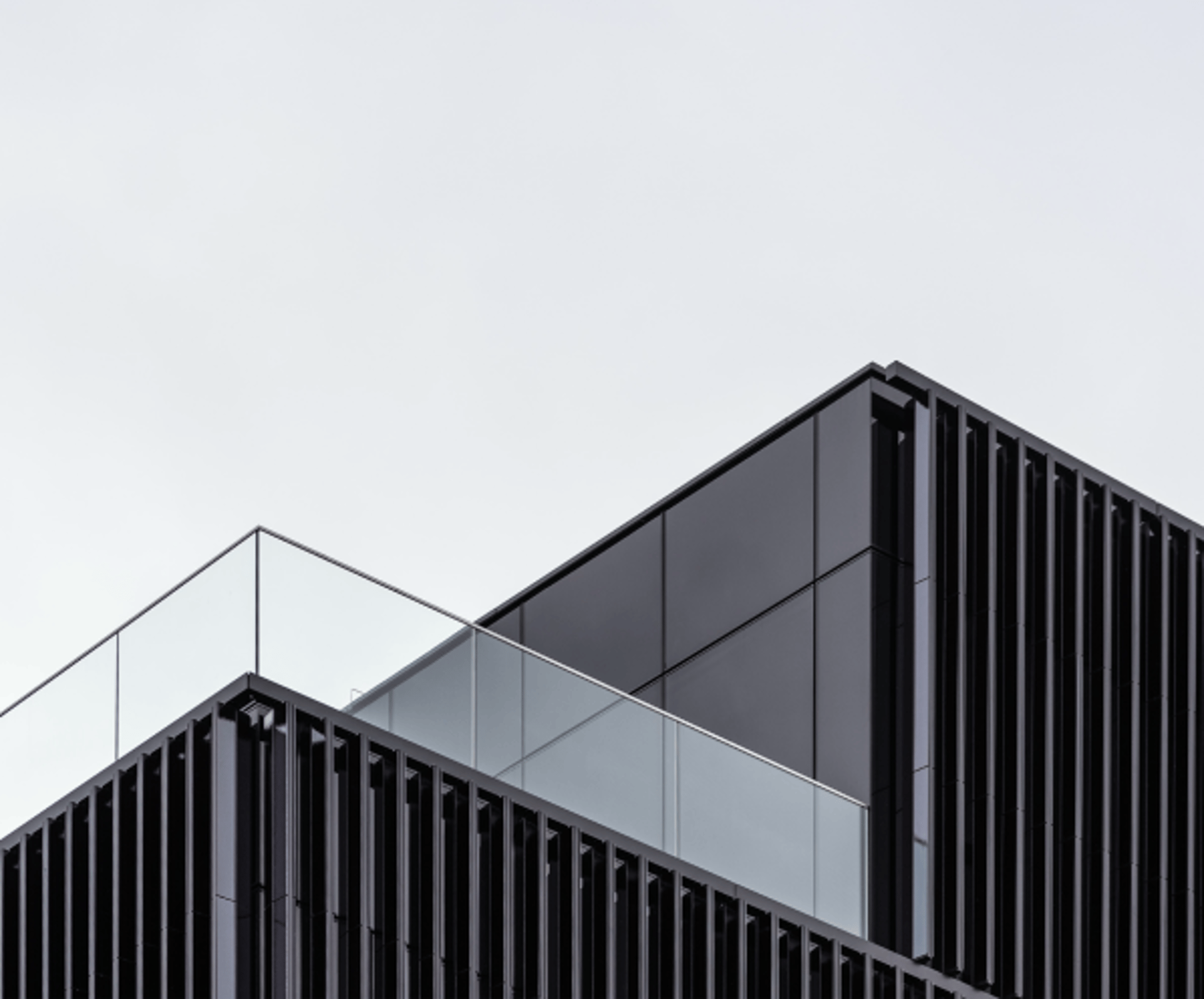an abstract photo of a curved building with a blue sky in the background