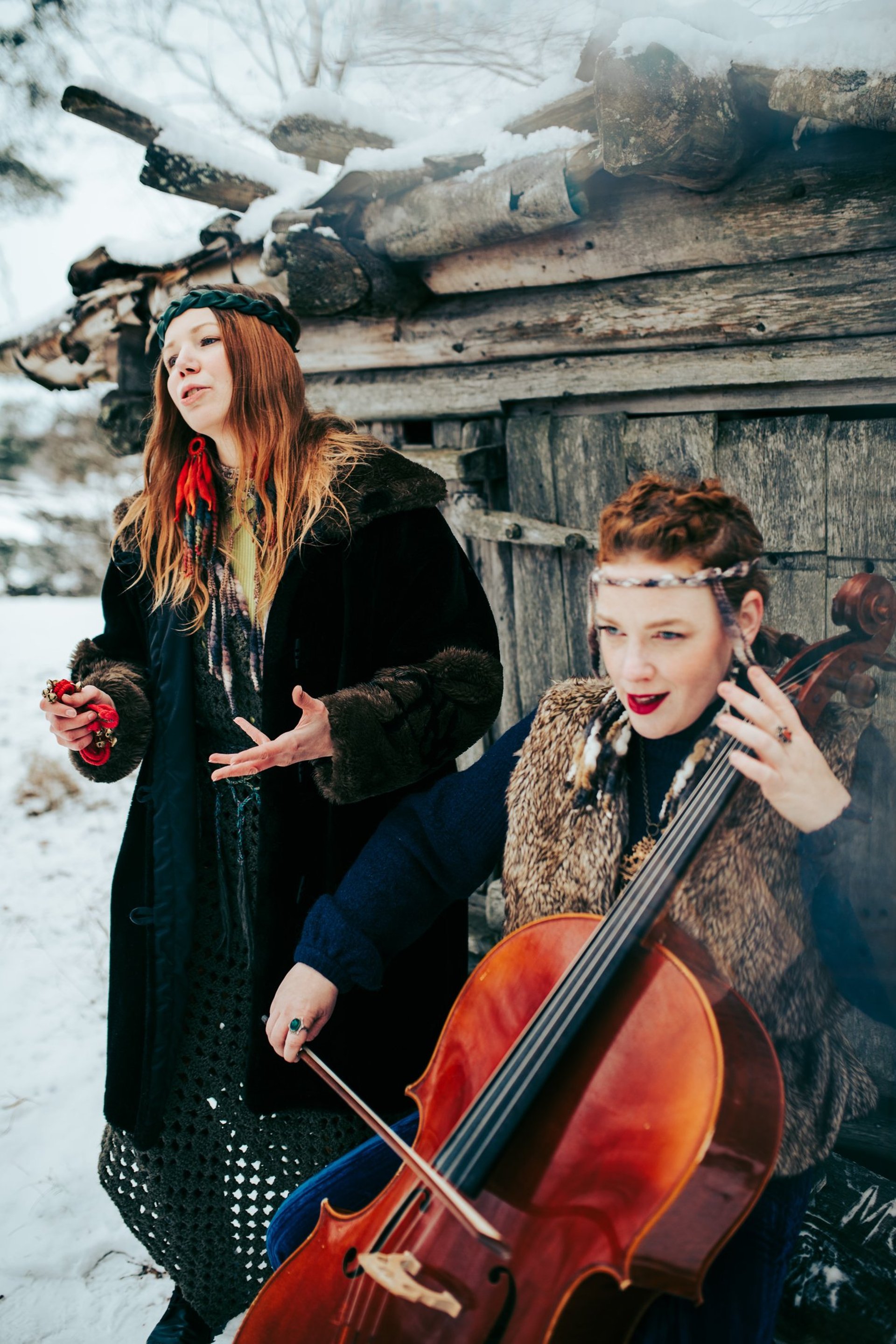woman in black jacket and white shorts jumping on road during daytime