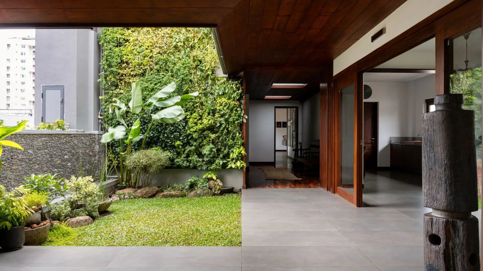 A lush, vibrant, low-maintenance vertical garden by FM Landscaping for private villa