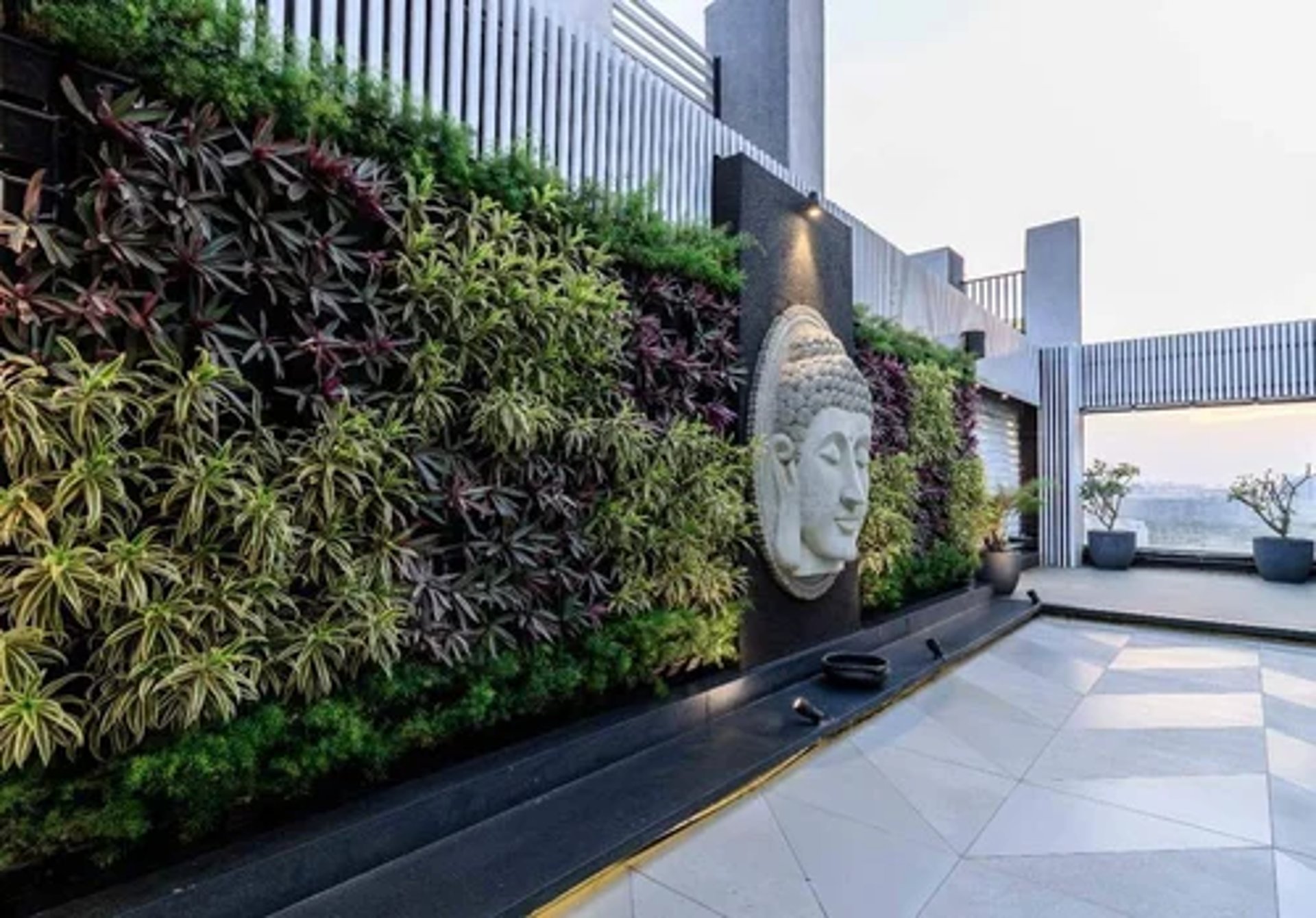 A lush, vibrant, low-maintenance vertical garden by FM Landscaping for resort