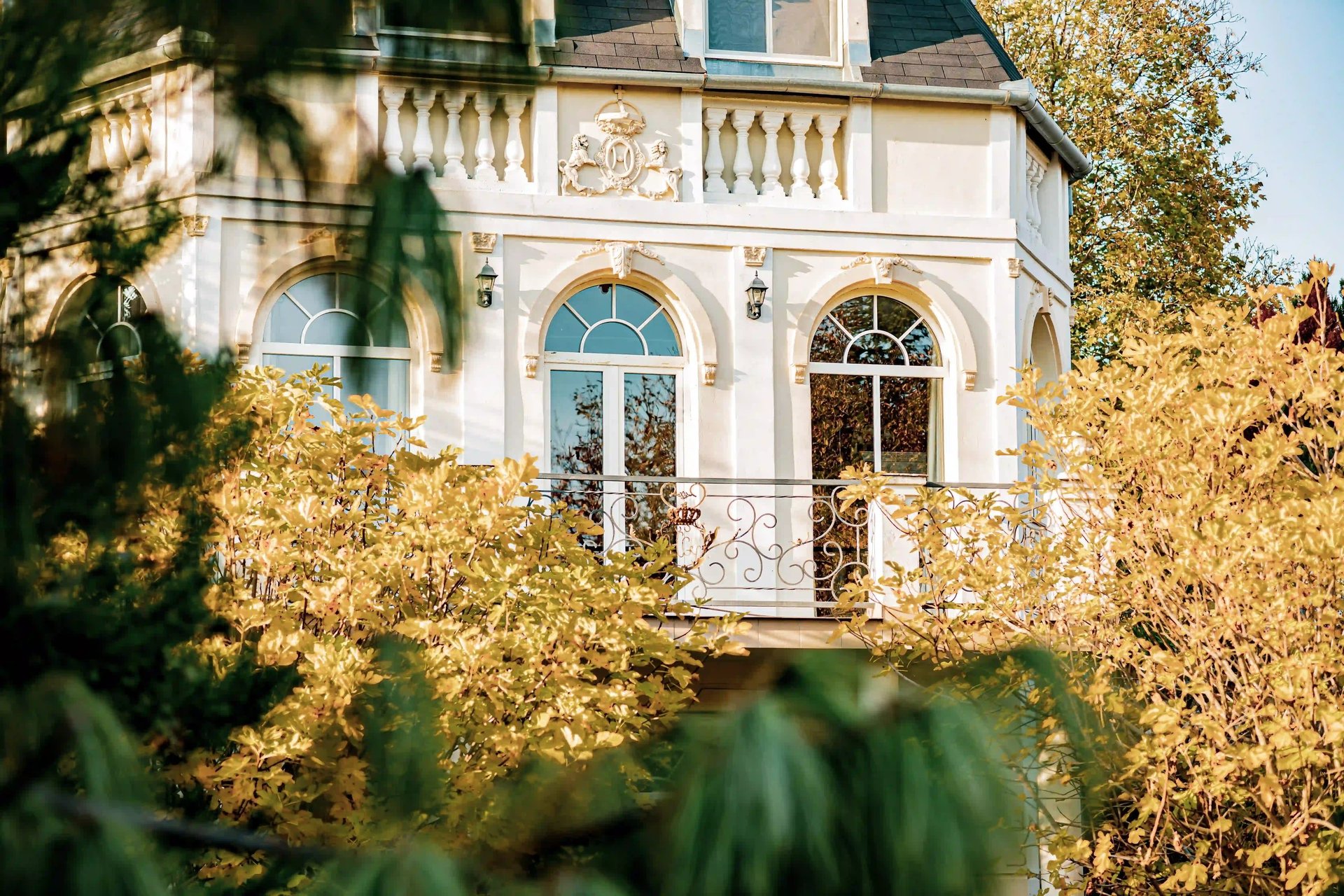 white and green concrete building near body of water during daytime