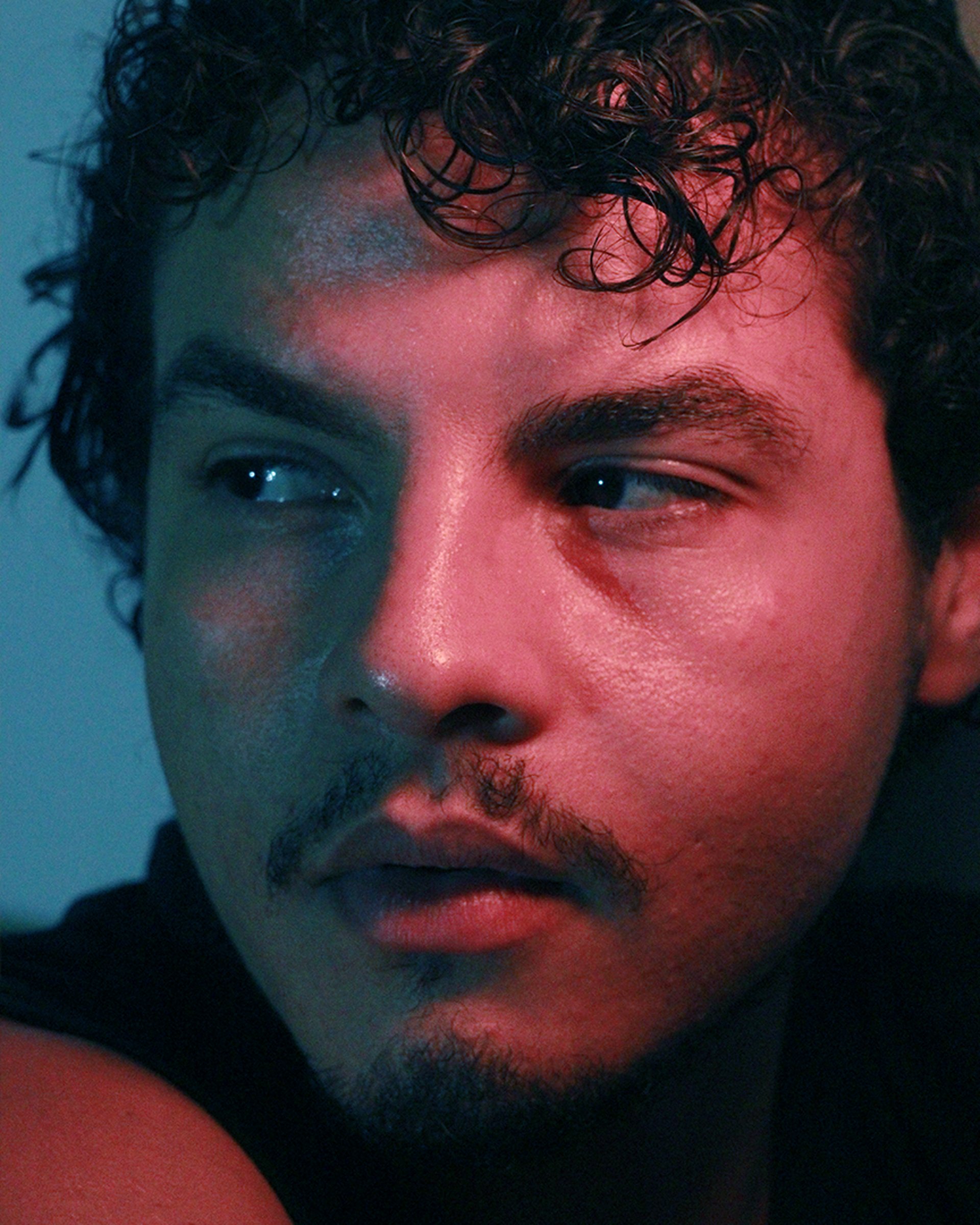 an abstract photo of a curved building with a blue sky in the background