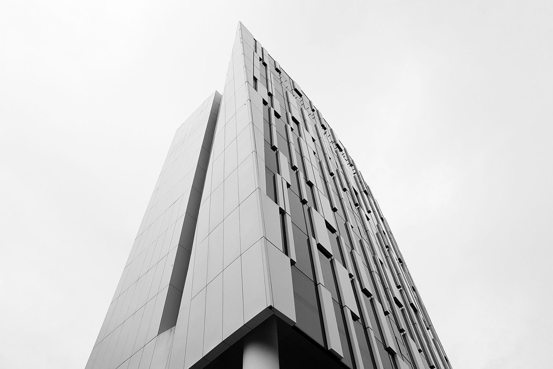 an abstract photo of a curved building with a blue sky in the background