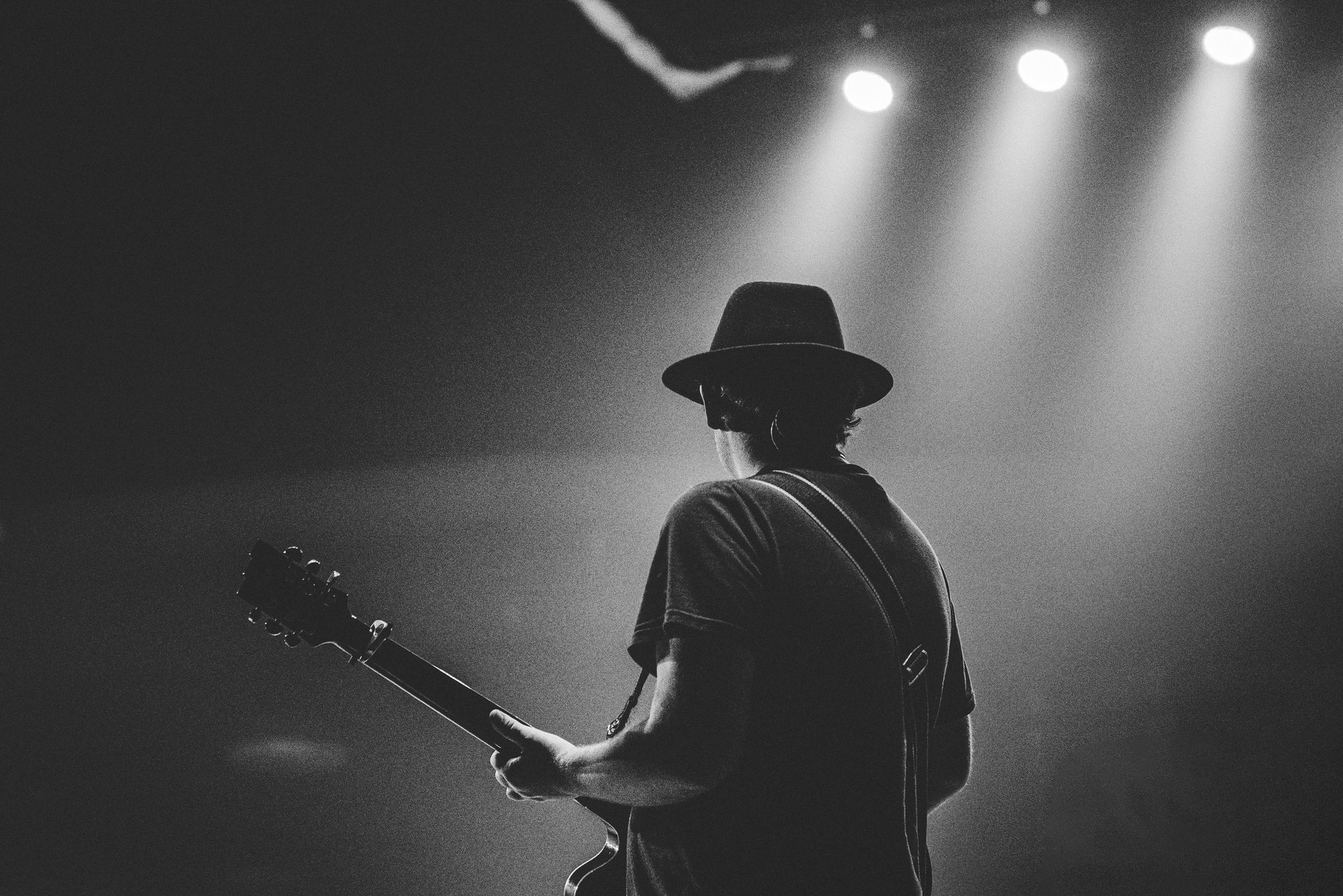 a close up of a guitar in the dark