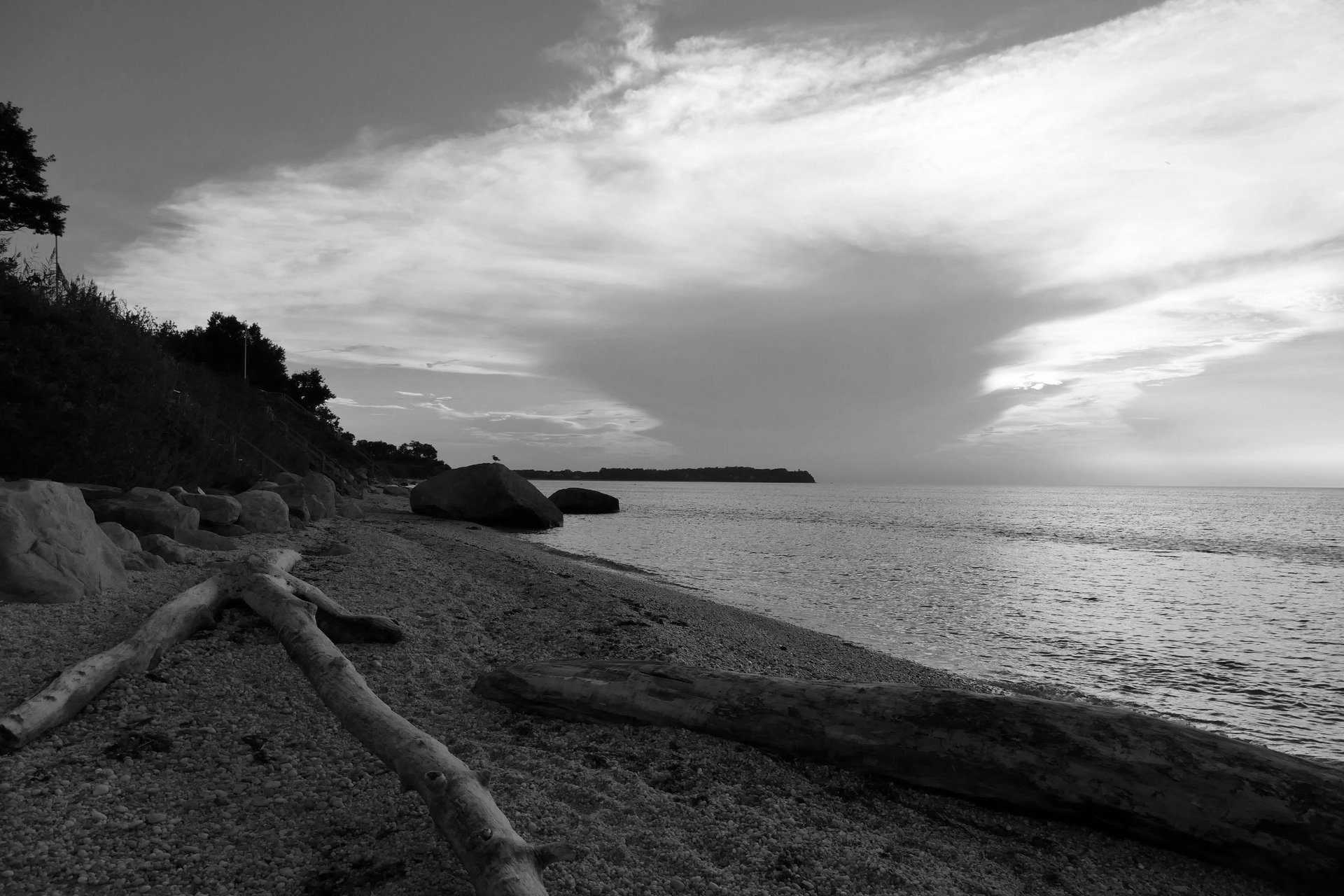 a light house sitting on top of a hill next to the ocean