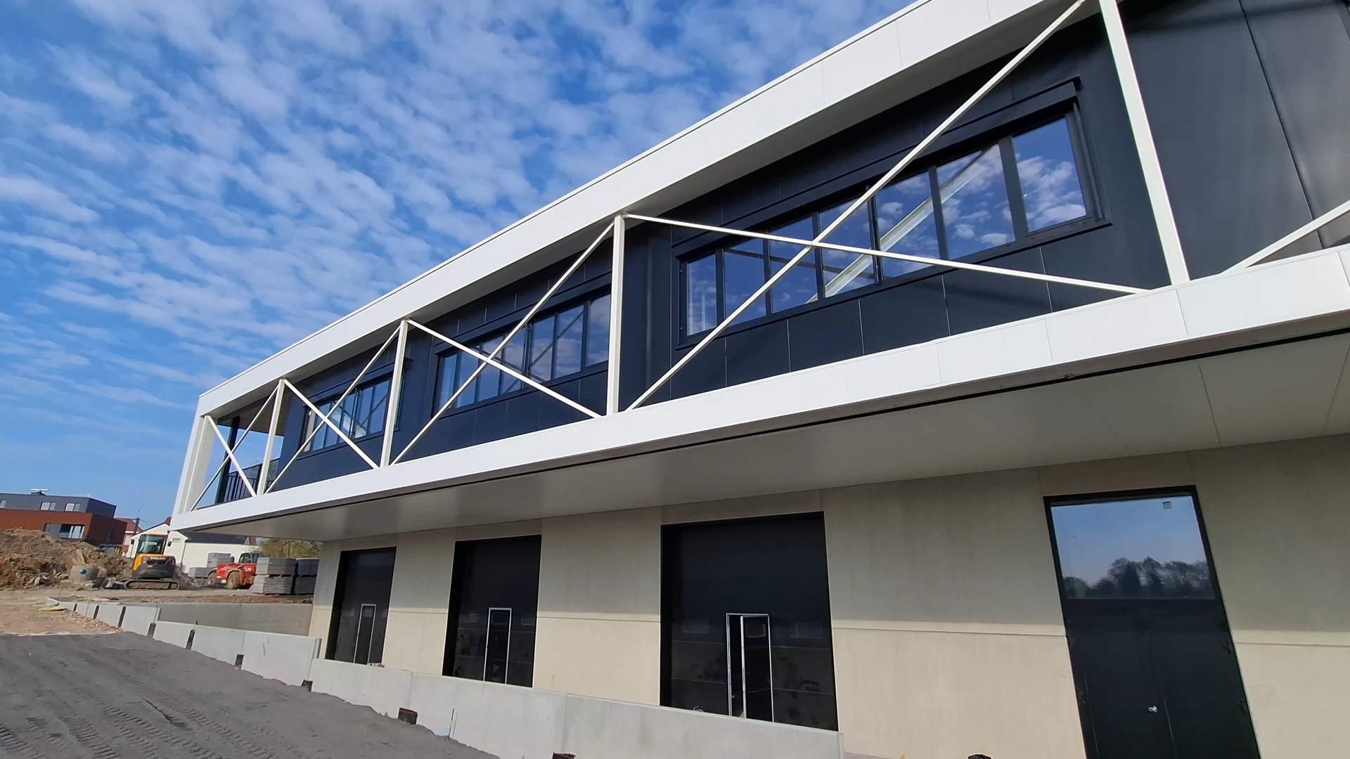 an abstract photo of a curved building with a blue sky in the background