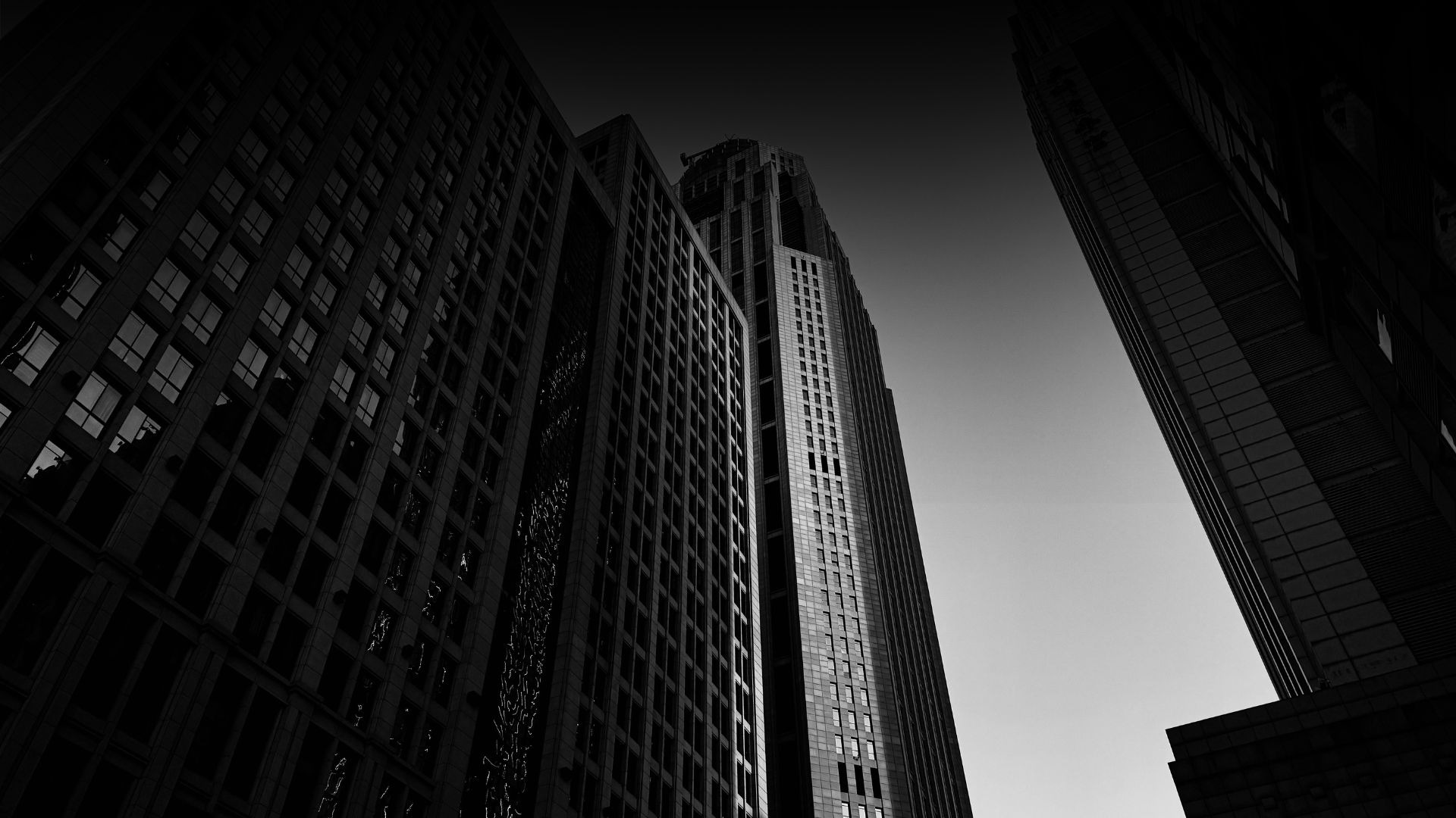 an abstract photo of a curved building with a blue sky in the background
