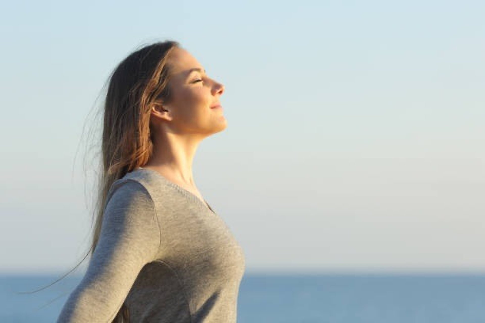 woman wearing yellow long-sleeved dress under white clouds and blue sky during daytime