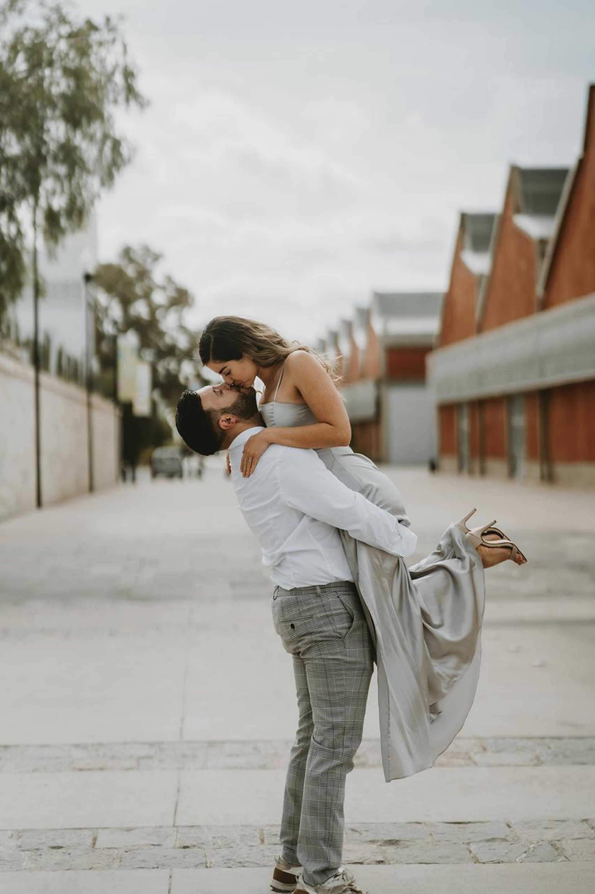 woman in black and white floral dress standing on brown rock during daytime