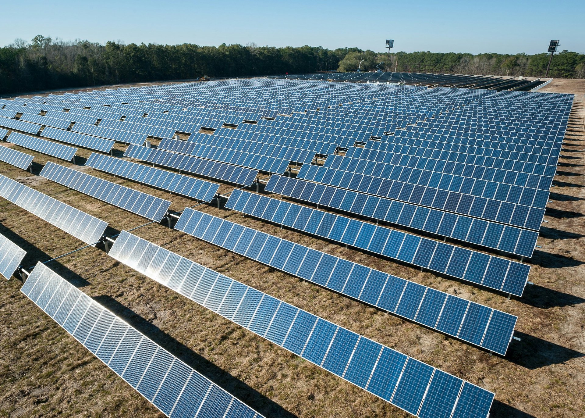 aerial photography of grass field with blue solar panels