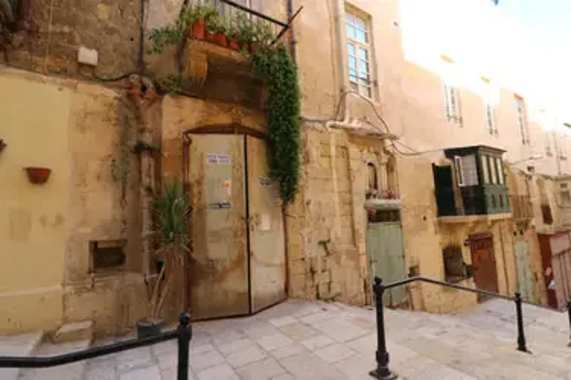 an abstract photo of a curved building with a blue sky in the background