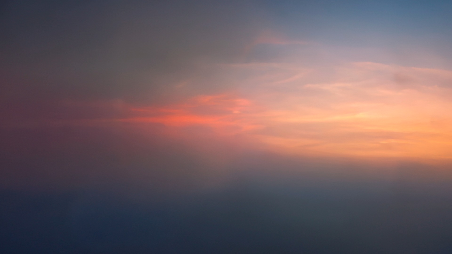 an abstract photo of a curved building with a blue sky in the background
