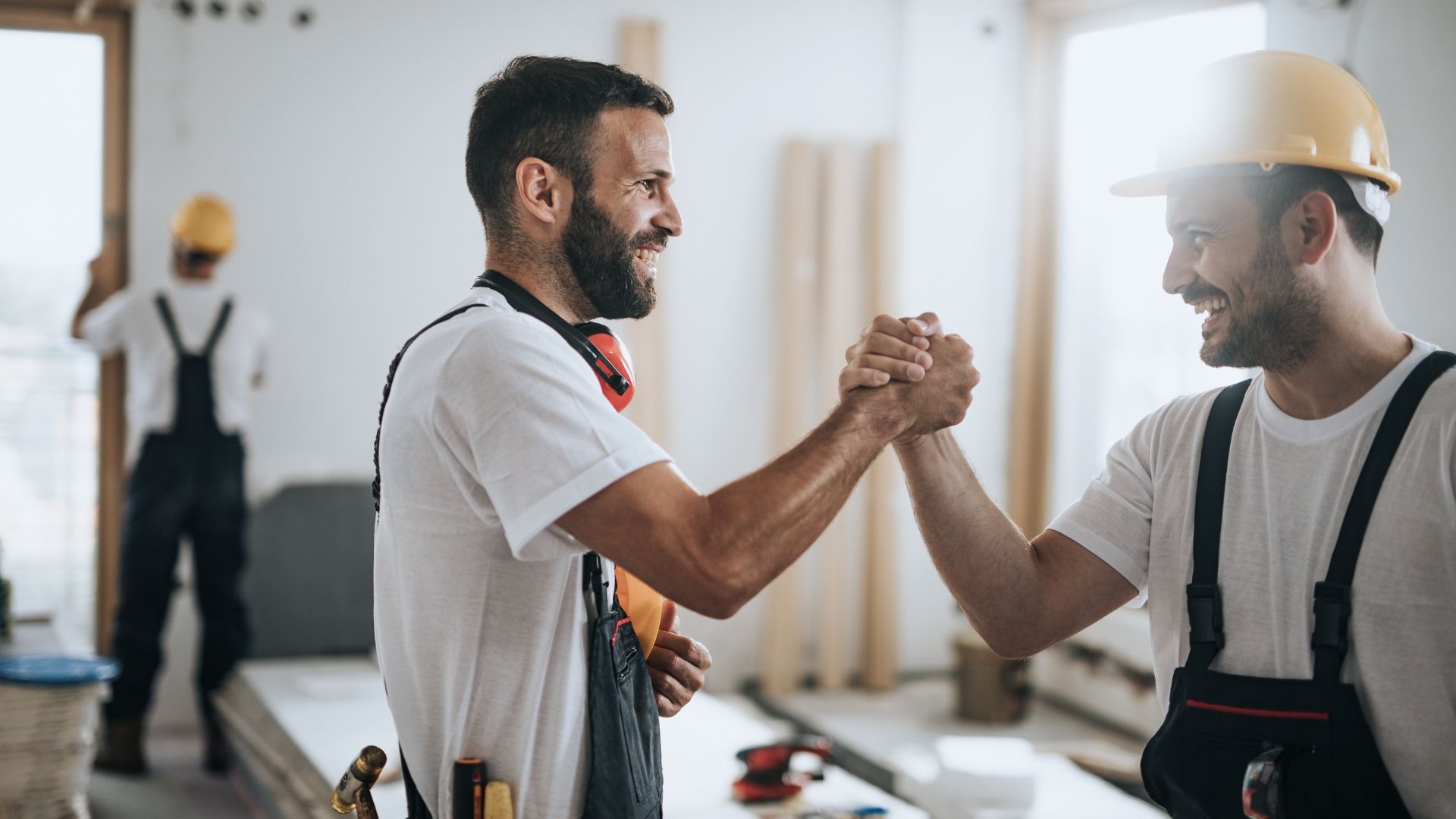Four professionals in business attire stand together.