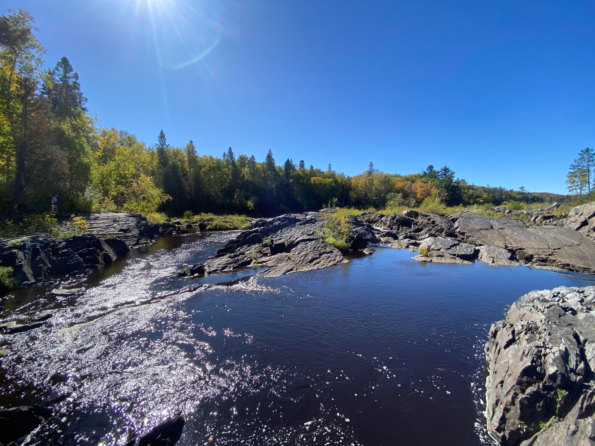 an abstract photo of a curved building with a blue sky in the background