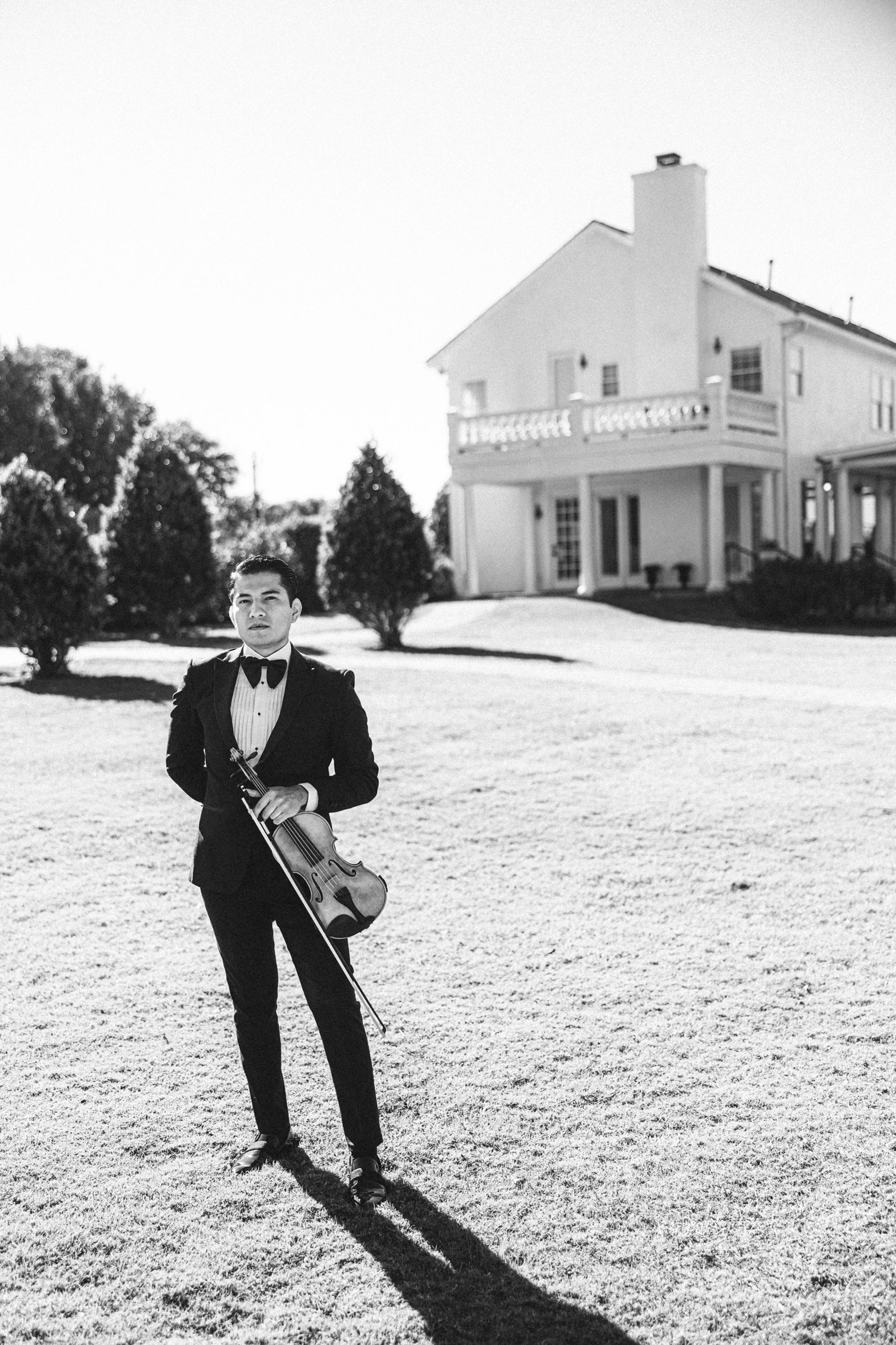 man and woman in wedding dress standing beside white floral curtain