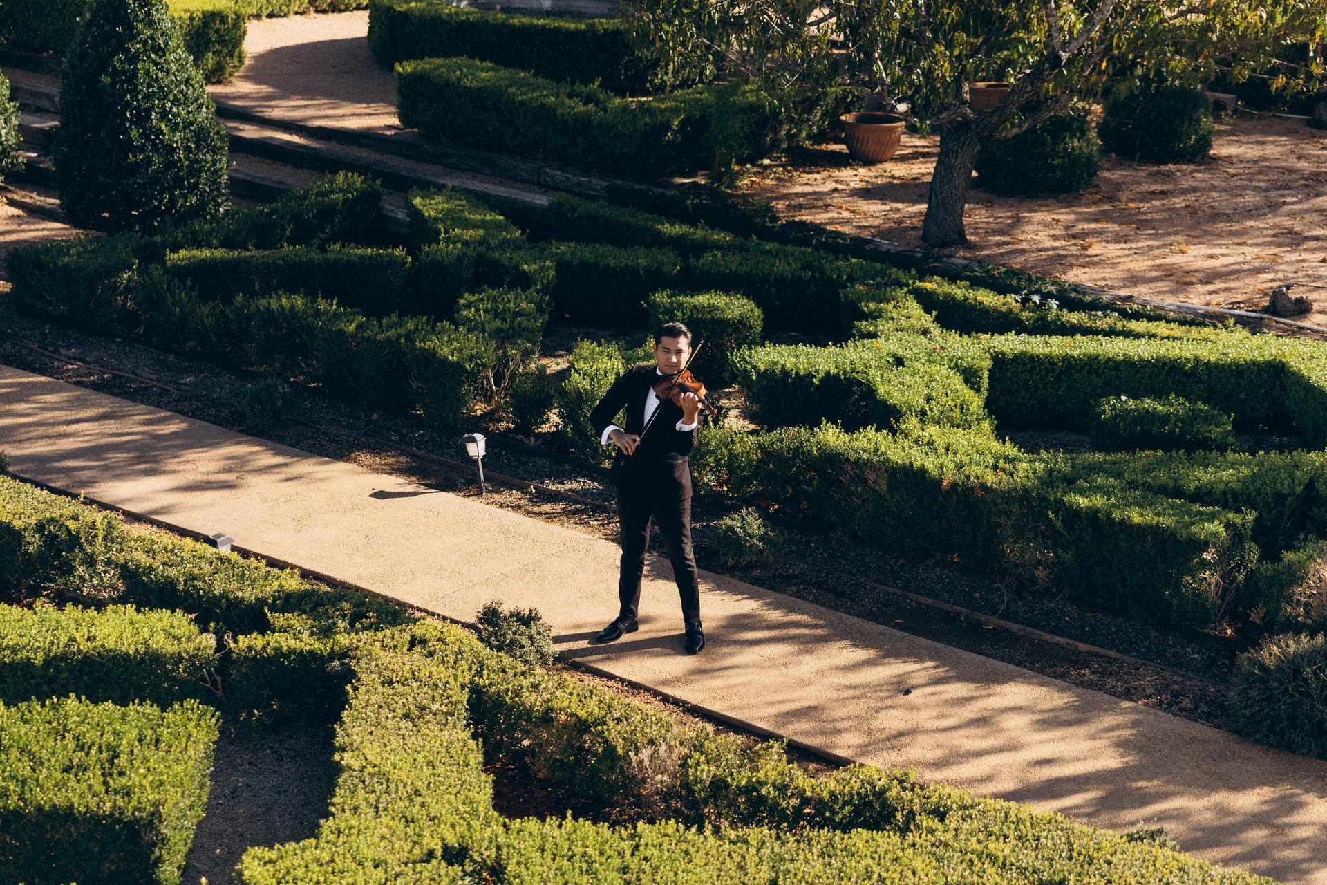 a violin sitting on top of a table next to an open book