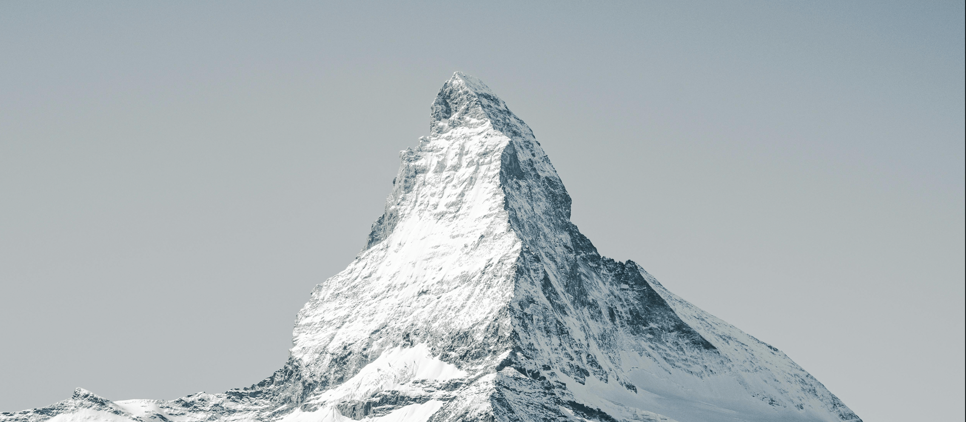 four brown wooden house on snow covered field