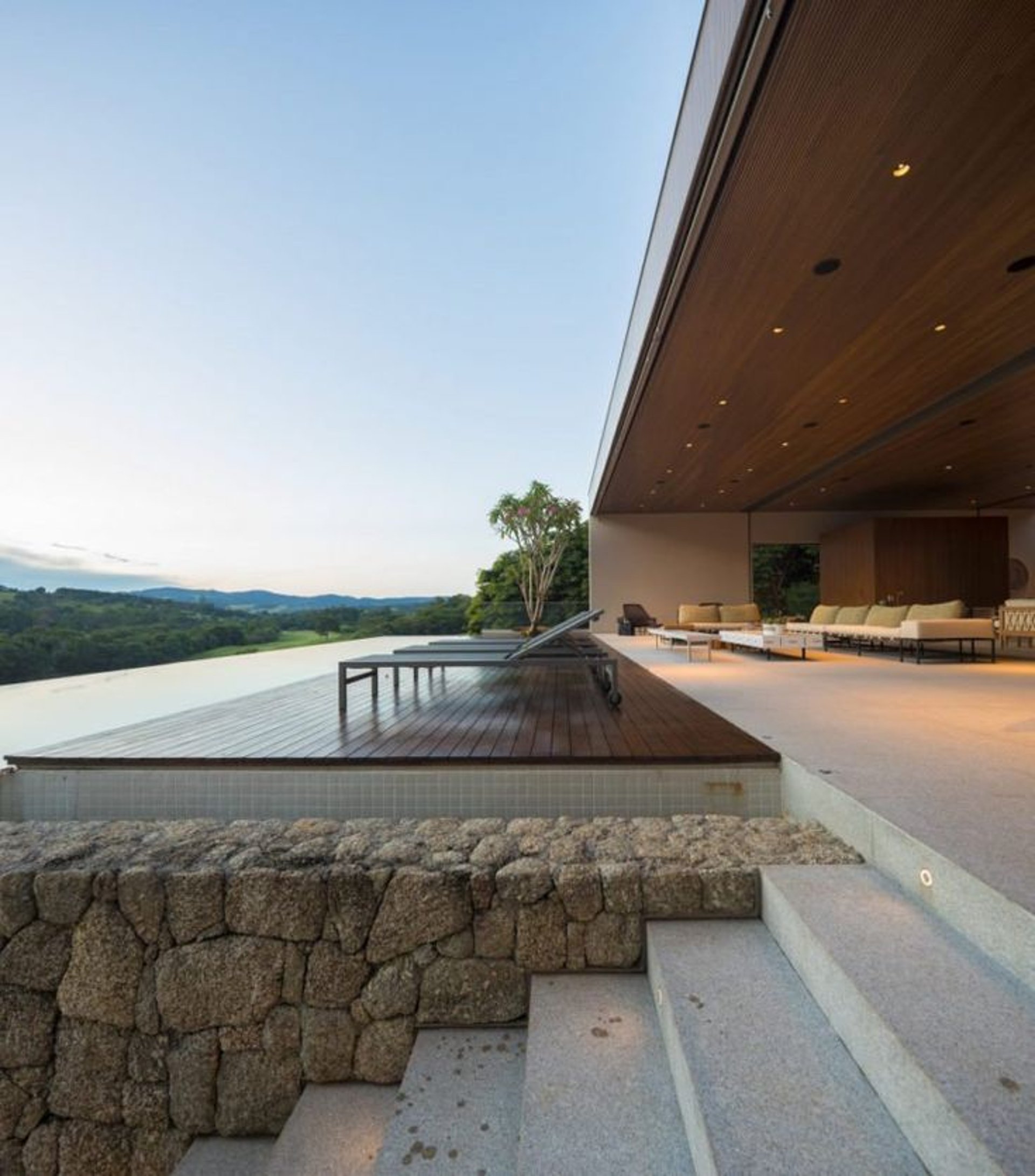 an abstract photo of a curved building with a blue sky in the background