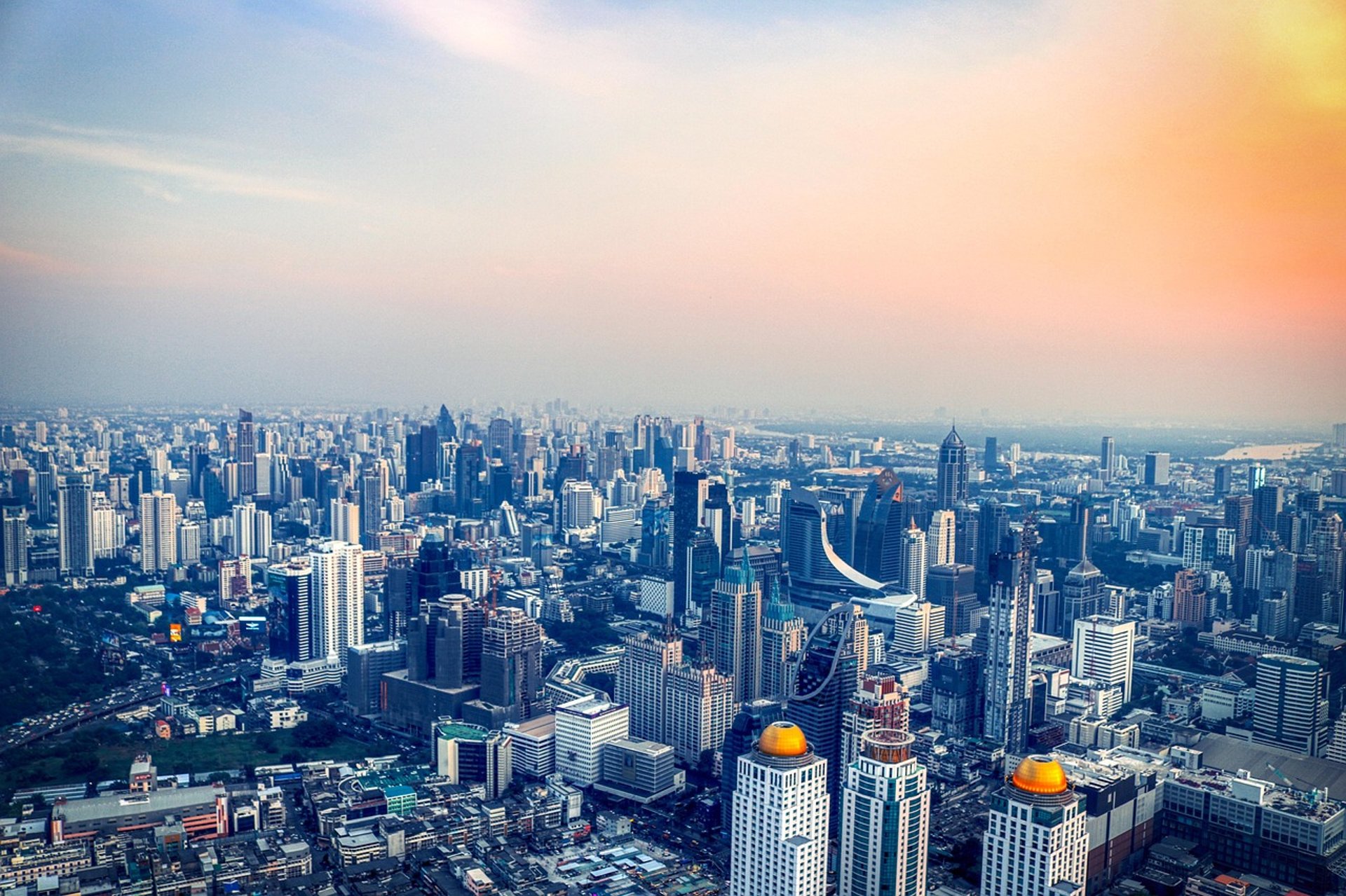 an abstract photo of a curved building with a blue sky in the background
