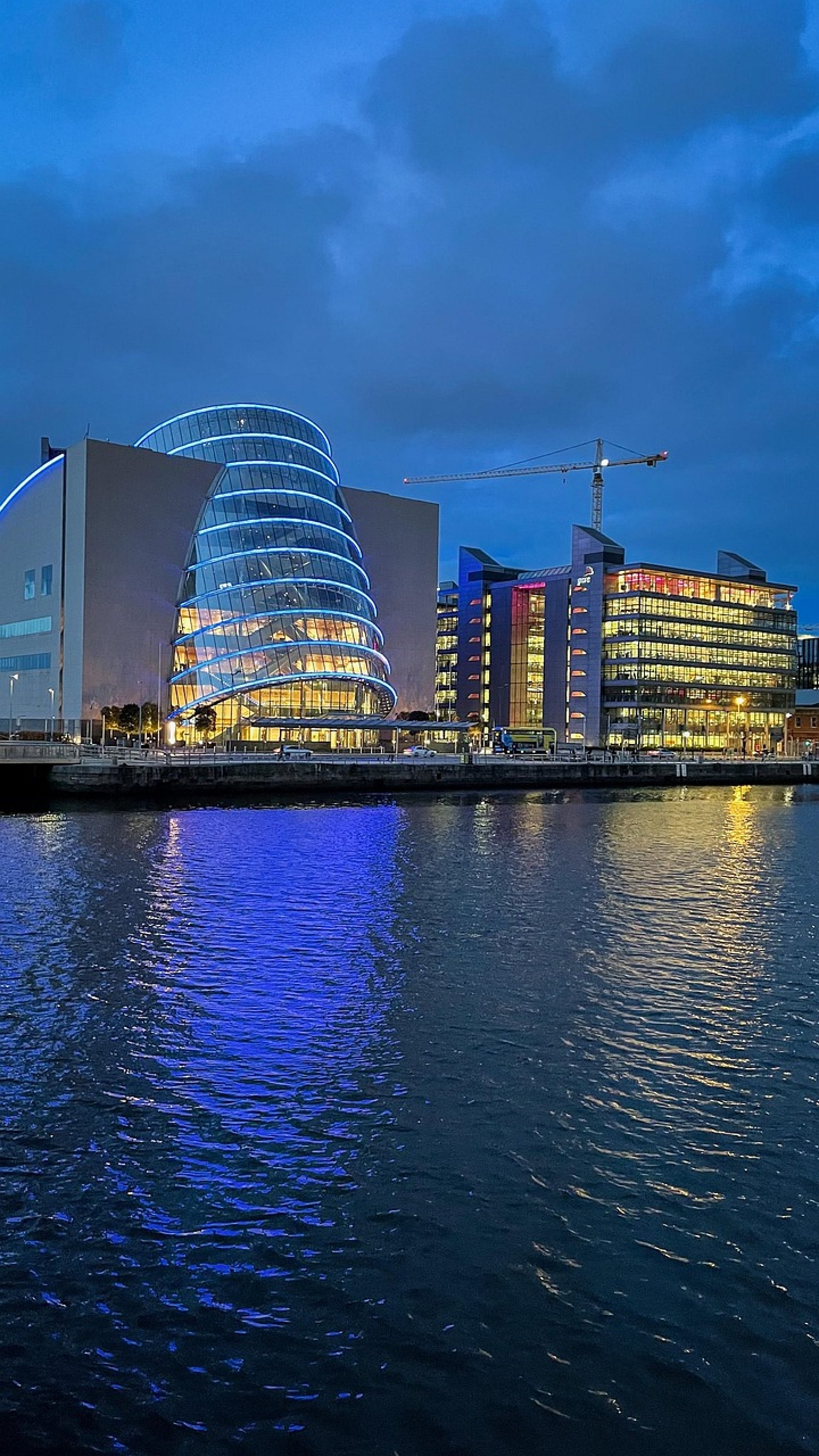 an abstract photo of a curved building with a blue sky in the background