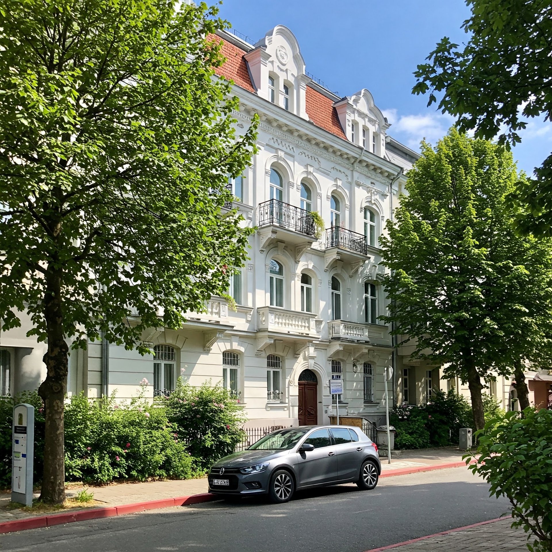 a blue car parked in front of a building