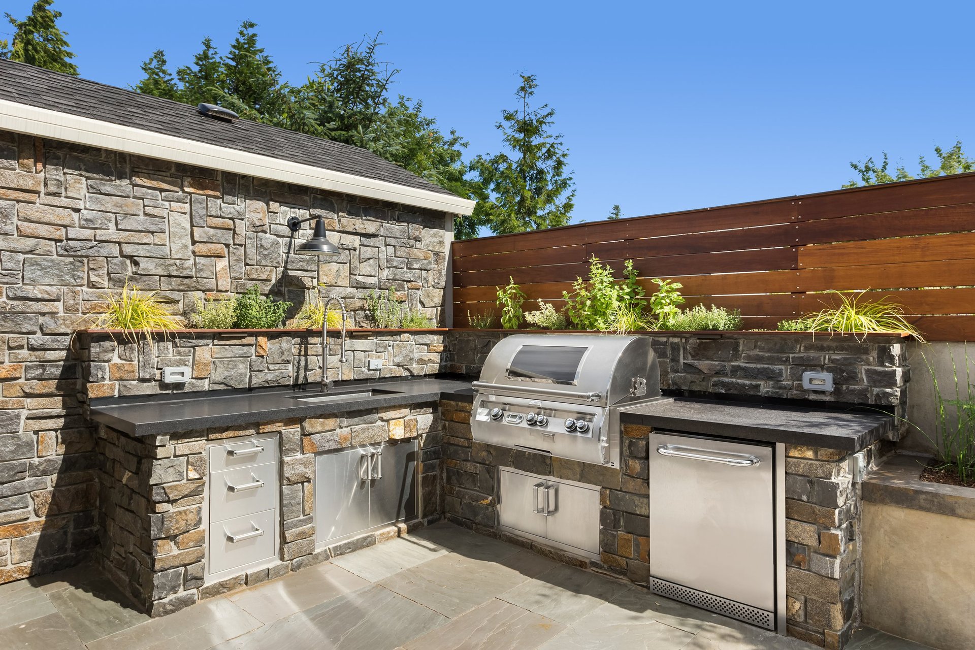 Outdoor cooking station with grill and prep counter in a Crescent Park backyard