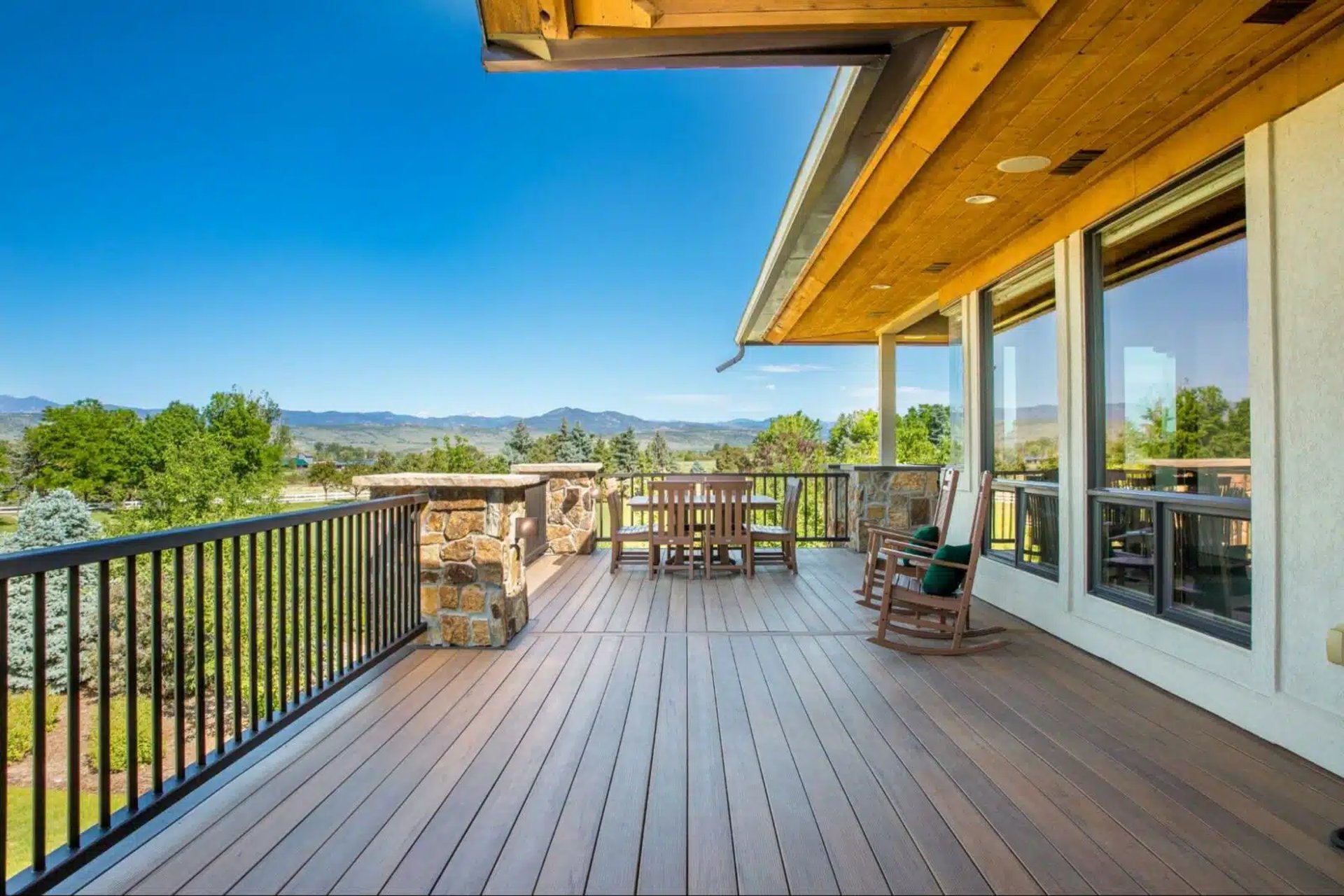 Custom-built deck and stone patio in Palo Alto backyard with outdoor seating and integrated lighting