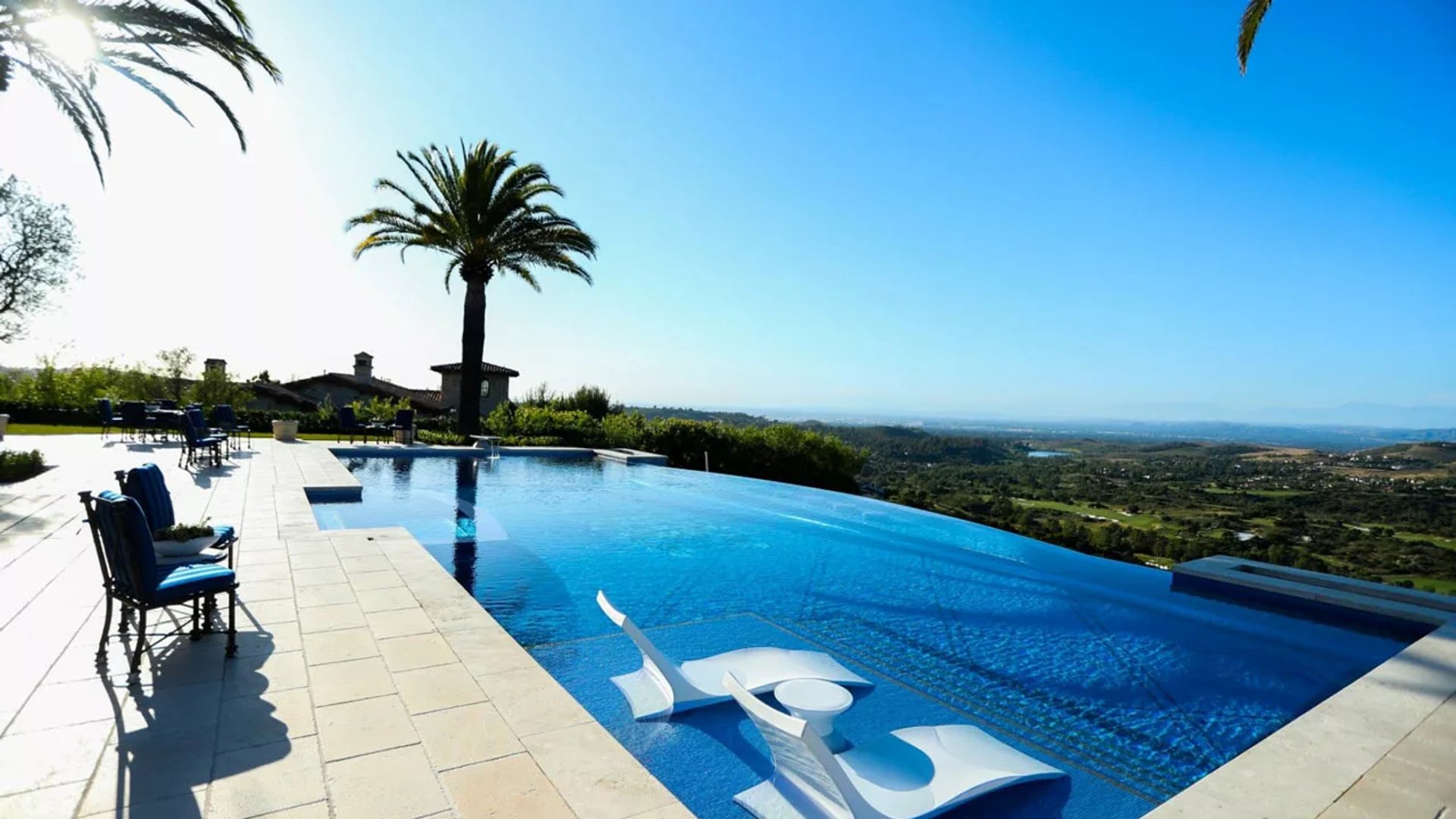 Custom luxury pool in Atherton featuring integrated spa, fire bowls, water features, and covered outdoor dining area