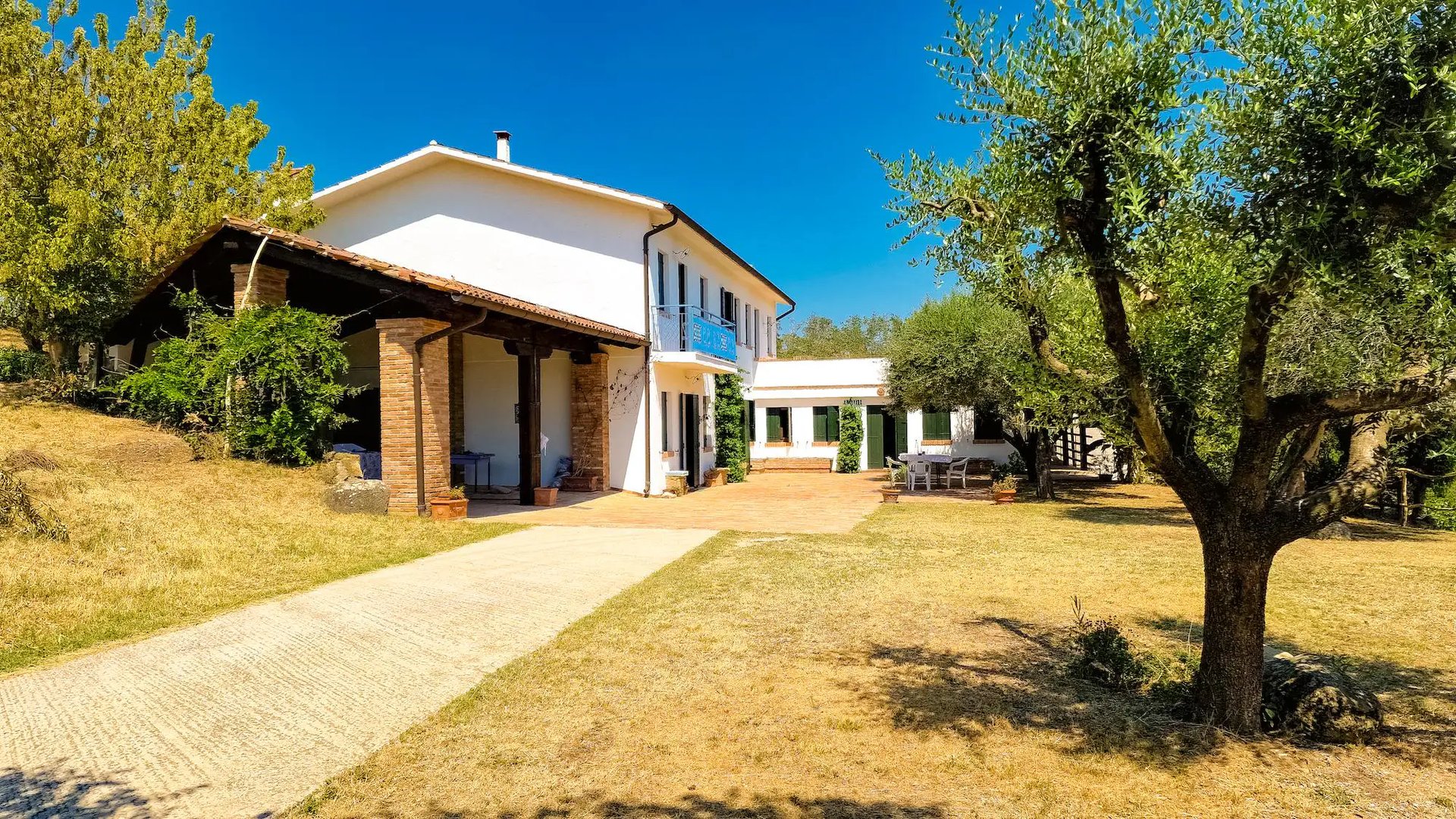 woman wearing yellow long-sleeved dress under white clouds and blue sky during daytime
