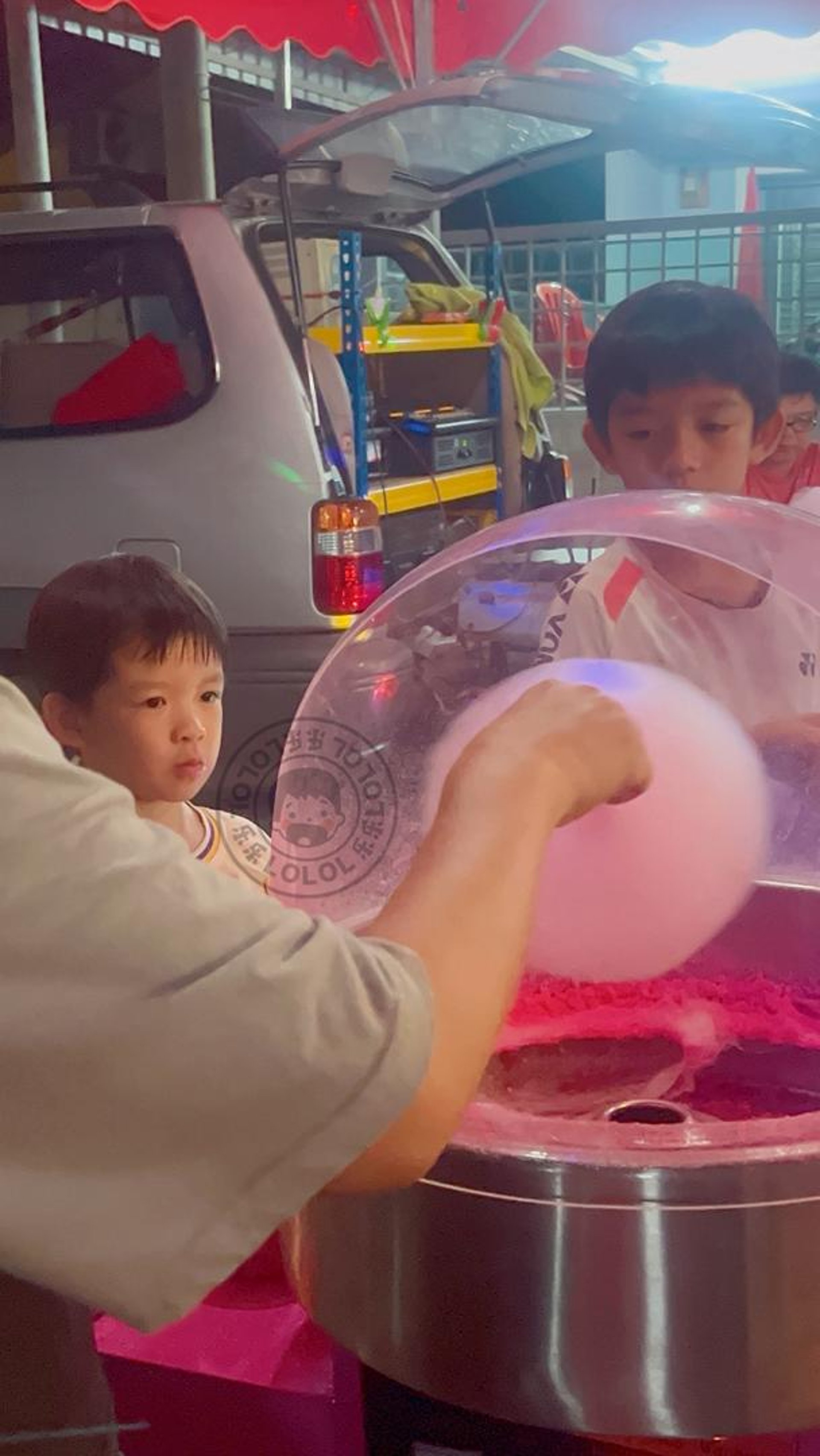 person holding red and white plastic container