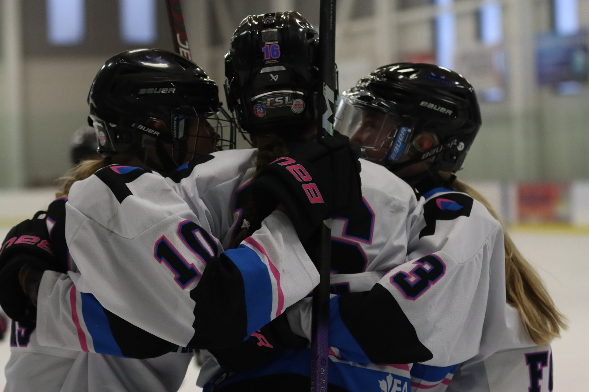 an indoor ice rink with a hockey goal
