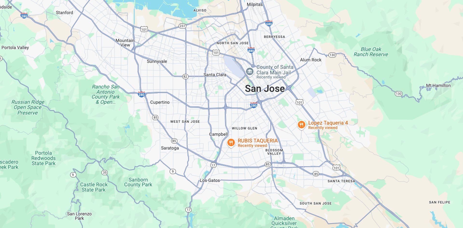 brown and white wooden house near green trees under blue sky during daytime