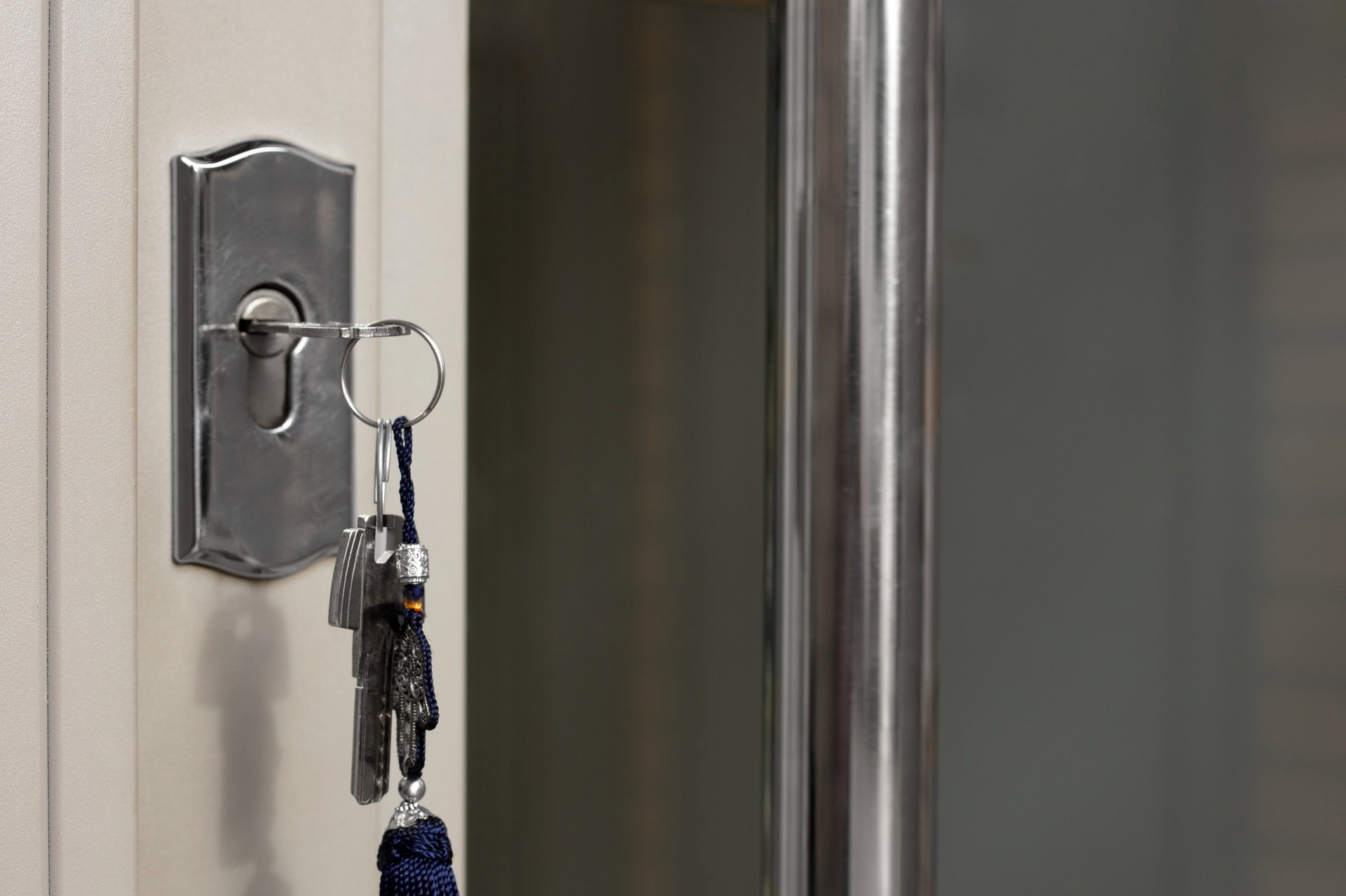 black and silver padlock on white door