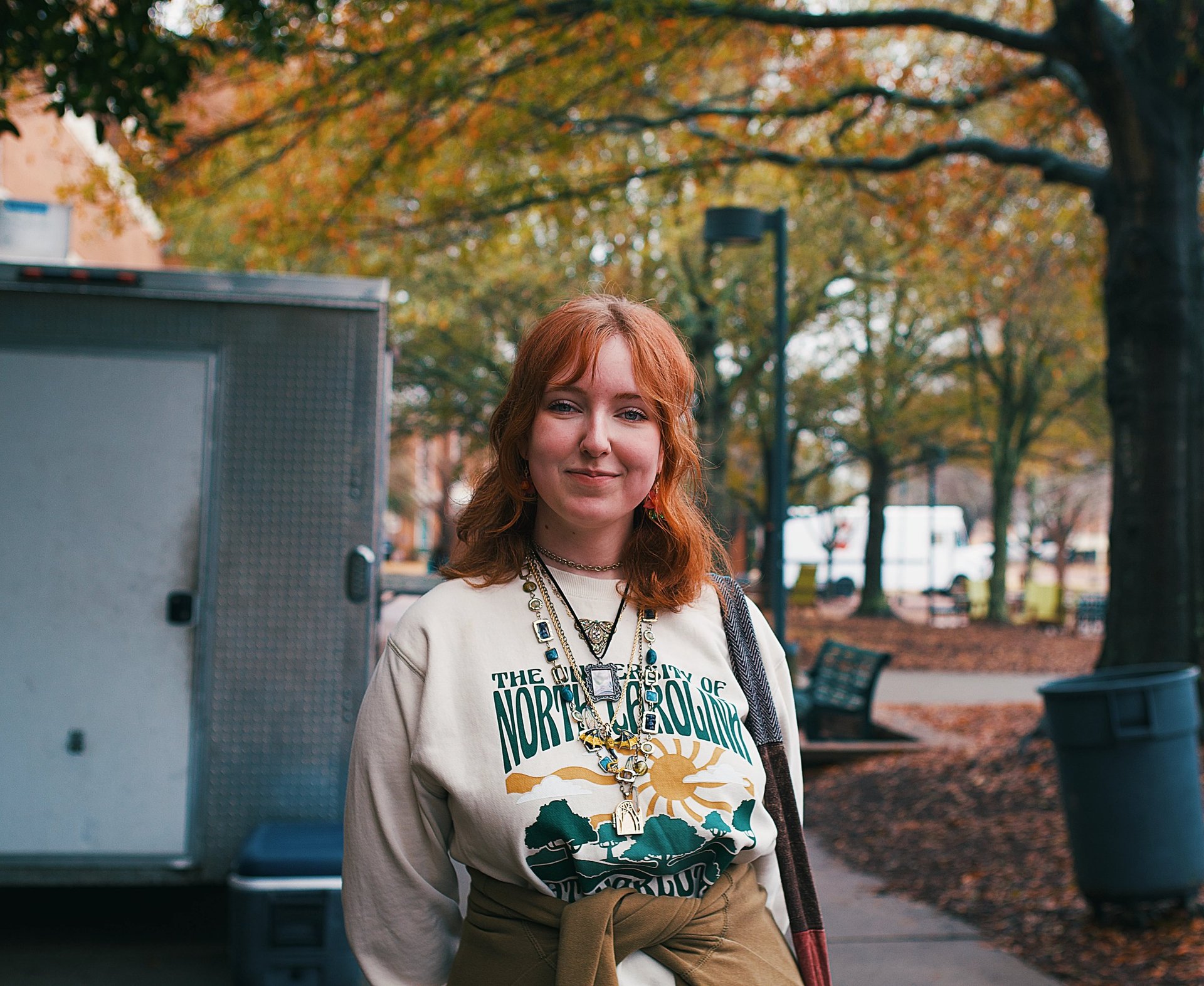 Young redheaded college woman smiling at camera.