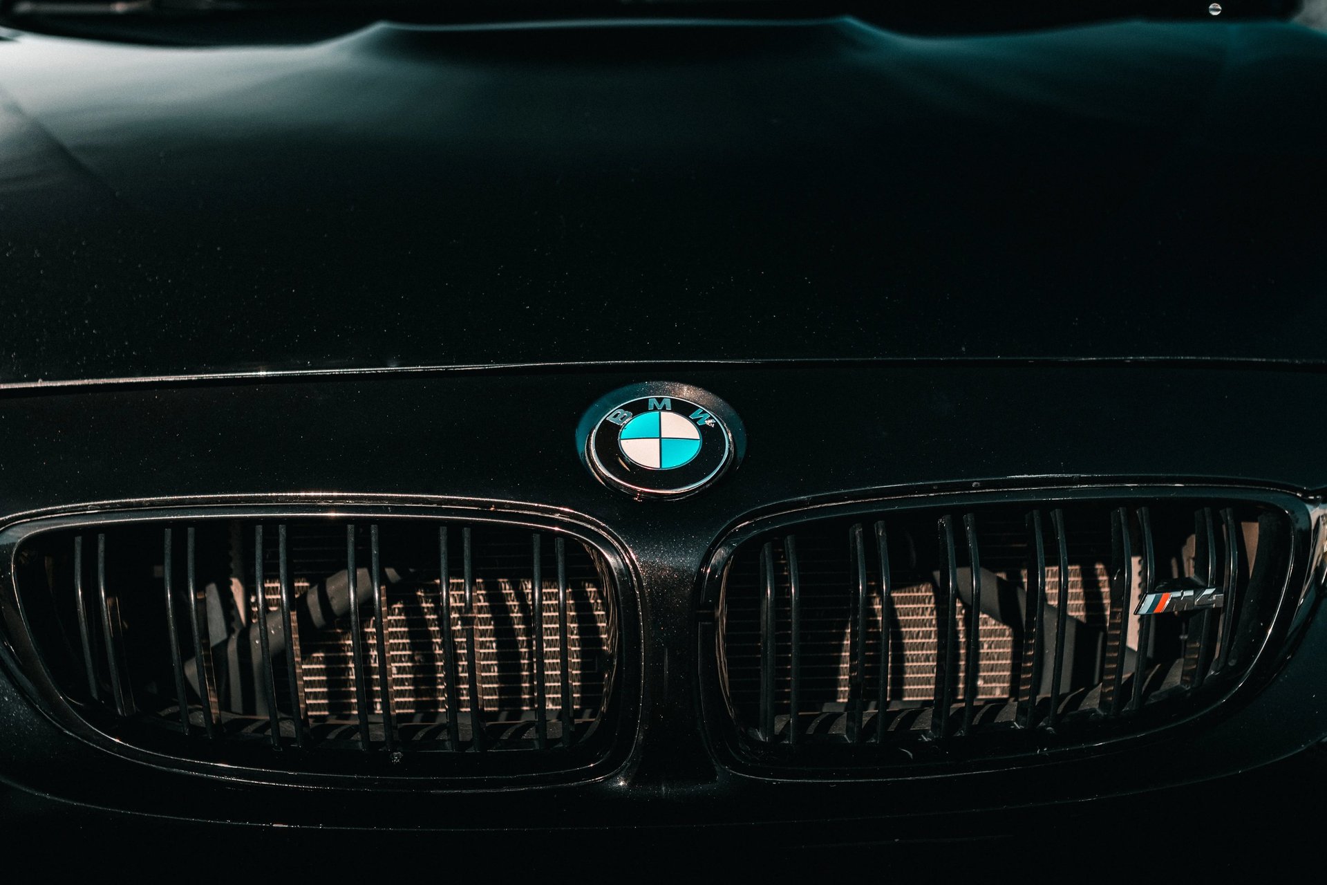 Electric blue BMW M3 Competition XDrive car photography at 704 Exotics in Charlotte, North Carolina.