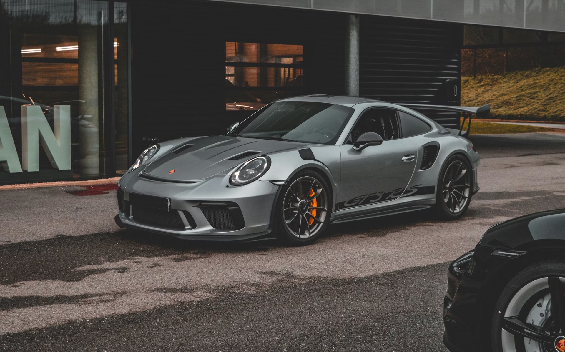 A yellow sports car driving on a track