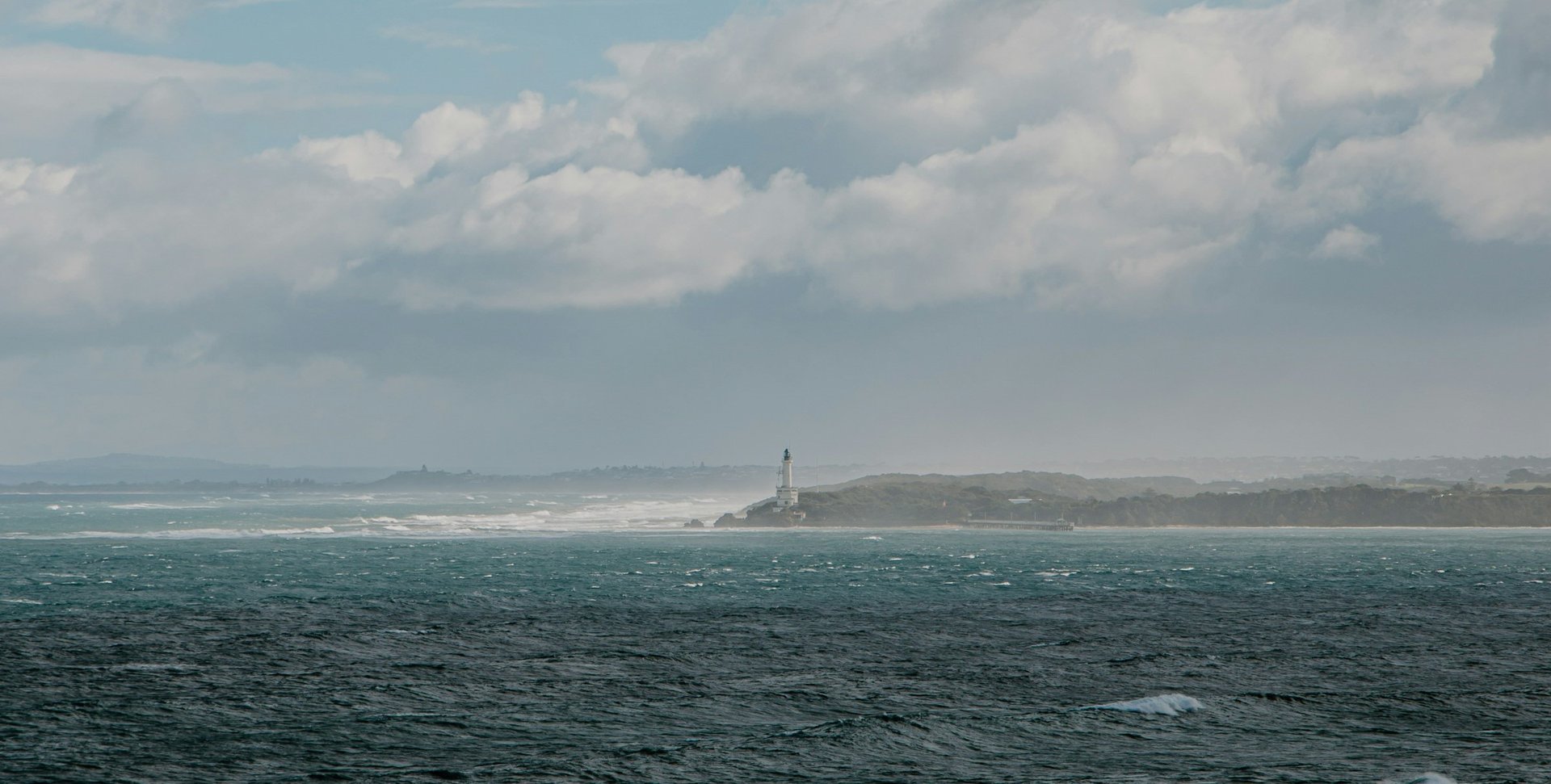 a large body of water sitting under a cloudy sky