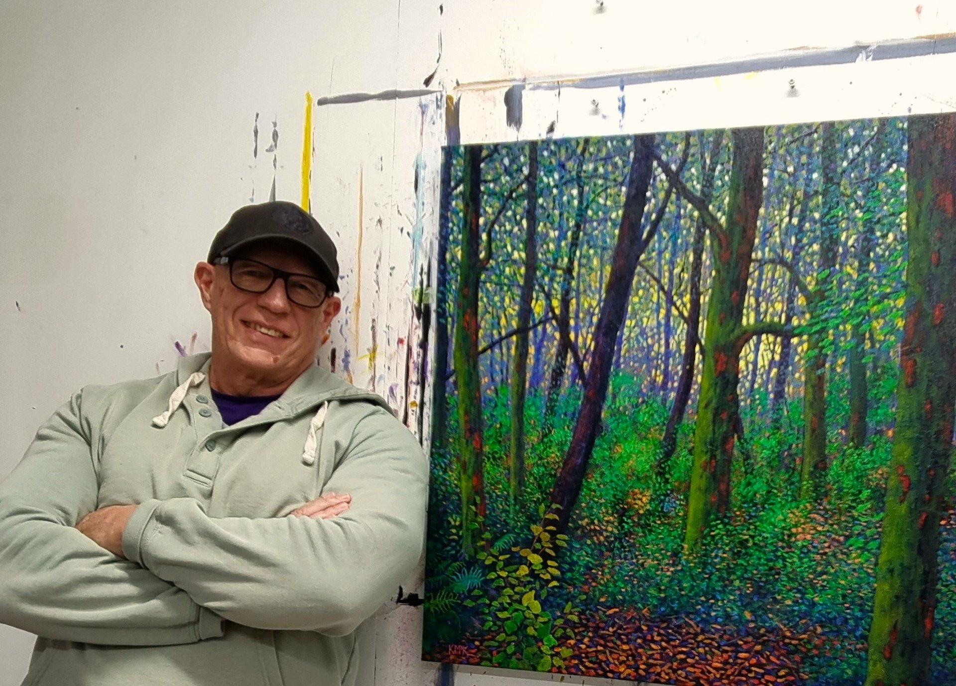 Kevin McKeown, Australian artist, sitting in his Perth studio surrounded by original abstract landscape paintings in his Chro