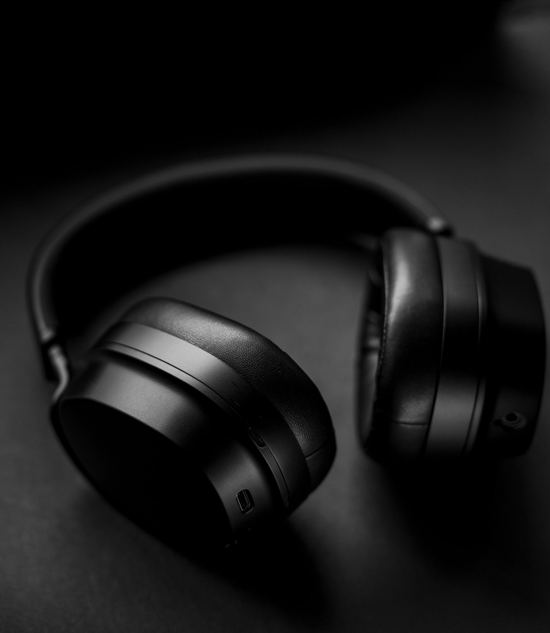 black corded headphones on blue background