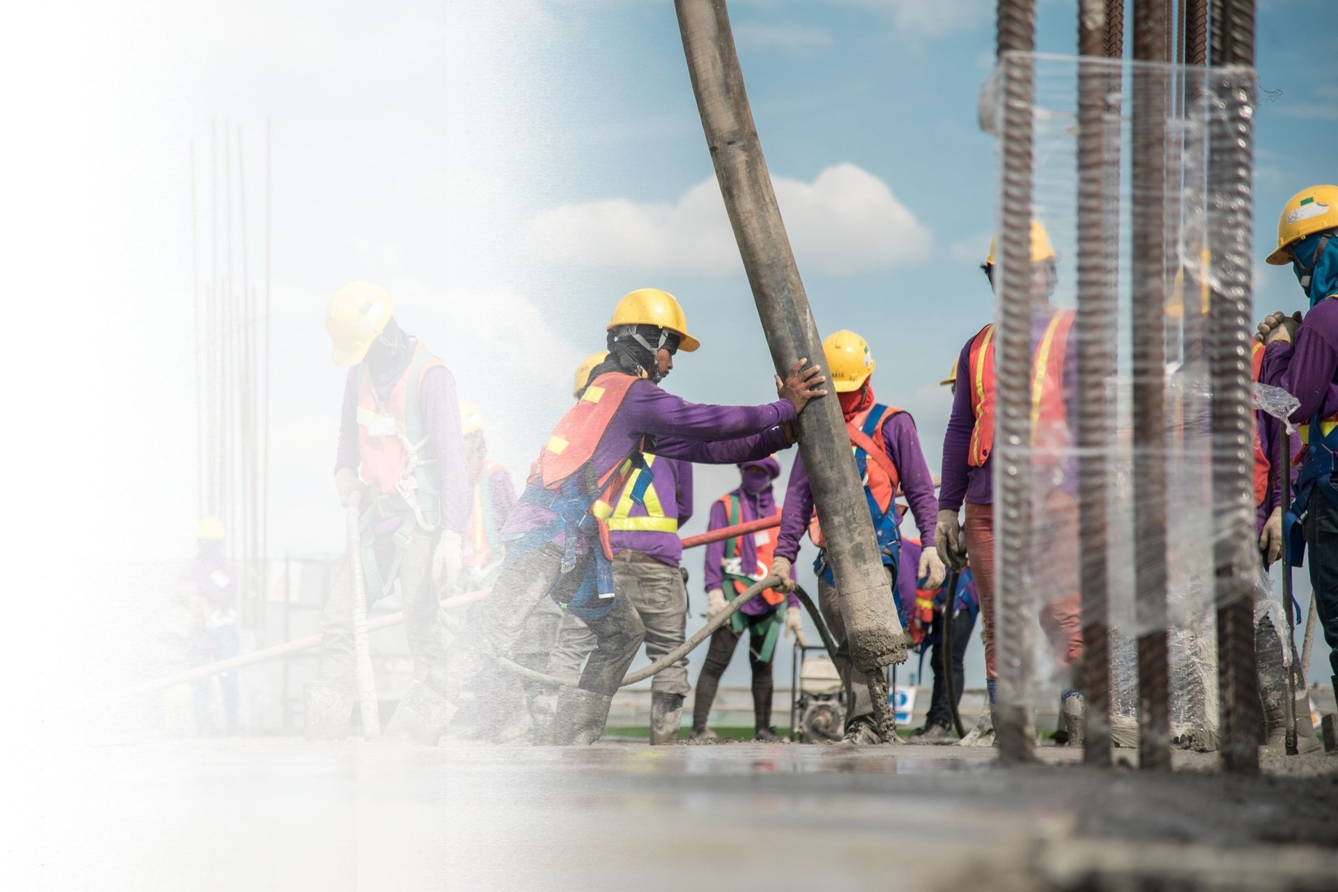 a group of men standing on top of a construction site